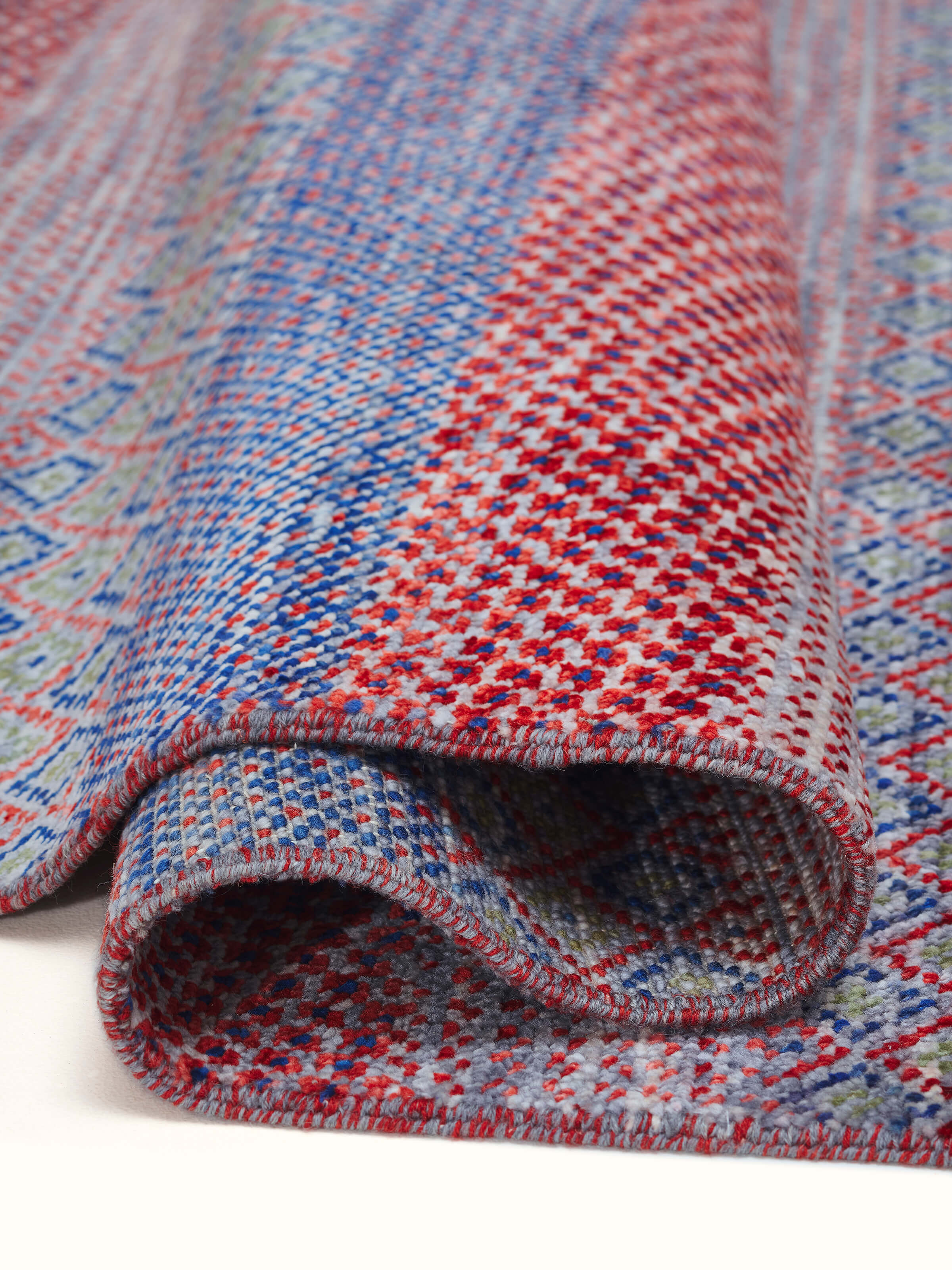 Full view of the hand-knotted Agra rug highlighting the grass pattern and its sophisticated design in a spacious setting