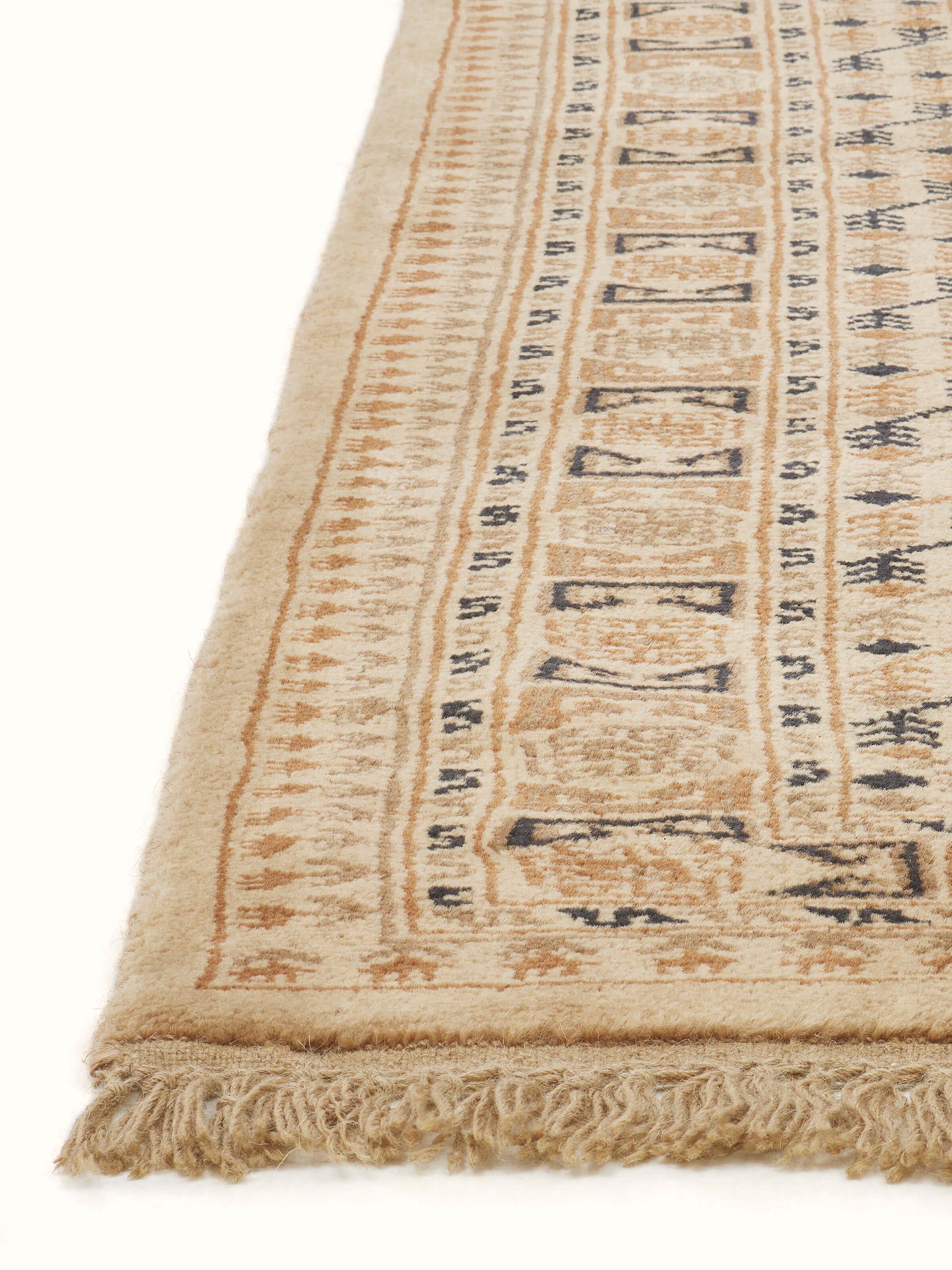 Traditional Bukhara beige rust Gwalior wool hand-knotted rug displayed in a room setting, illustrating its size and overall appearance