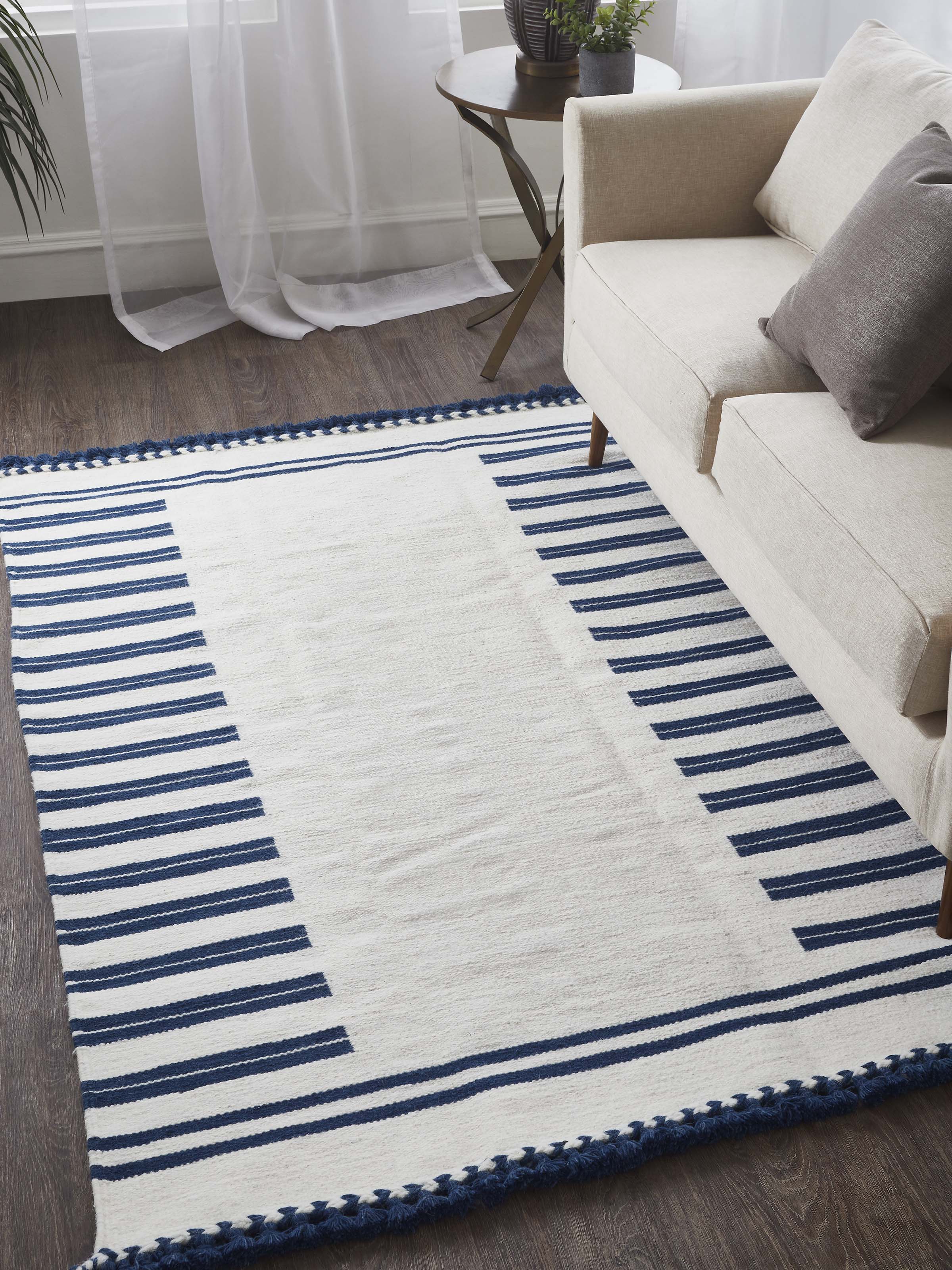 Detailed view of Geo border ivory blue Gujarat wool & cotton panja dhurrie kharad (4x6 ft) highlighting the wool texture and geometric design.