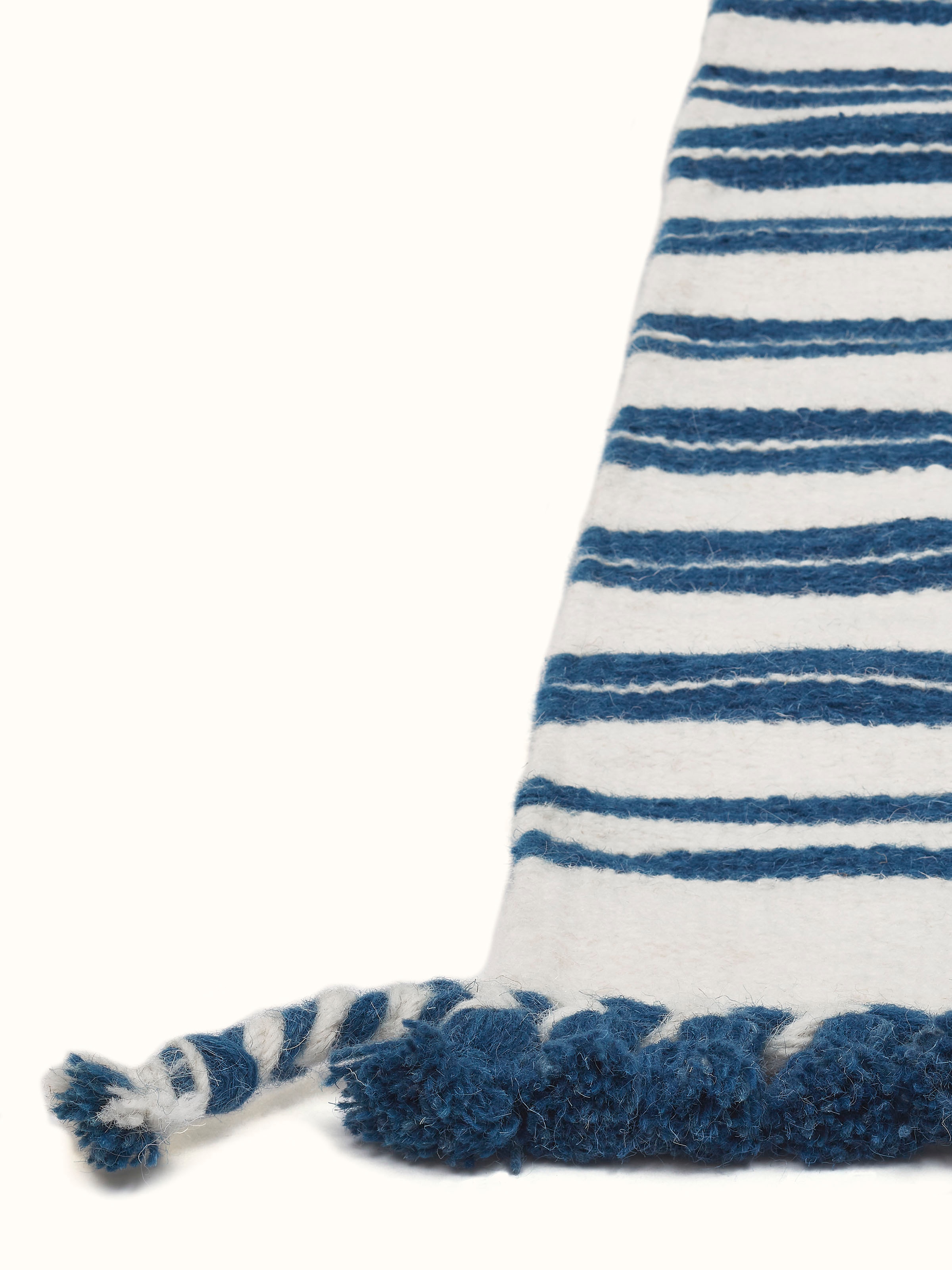 Close-up of Geo border ivory blue Gujarat wool & cotton panja dhurrie kharad (4x6 ft) focusing on the intricate border design and fabric.