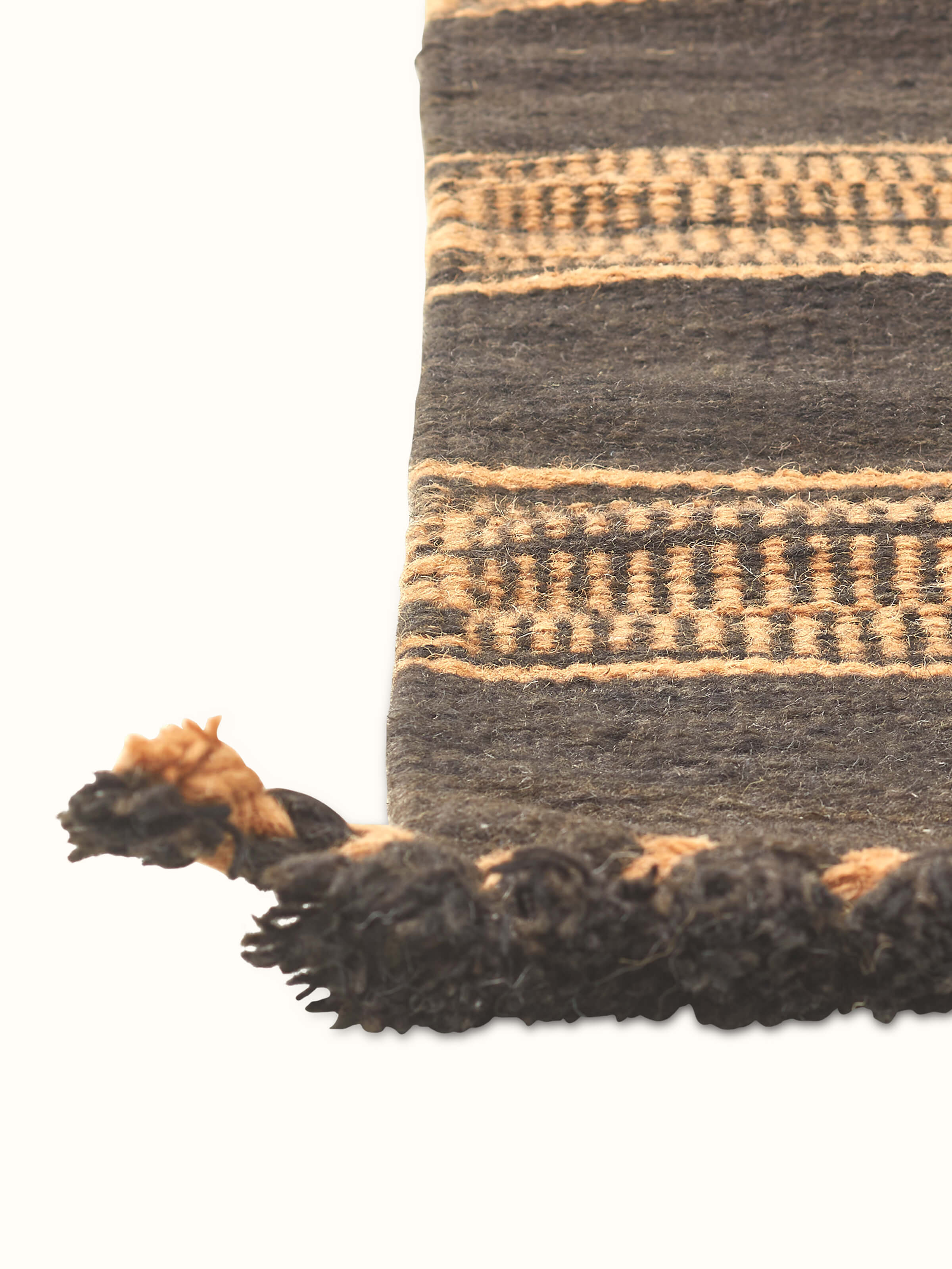 Detailed view of the geometric pattern on Geo Diamonds dark brown Gujarat wool & cotton panja dhurrie