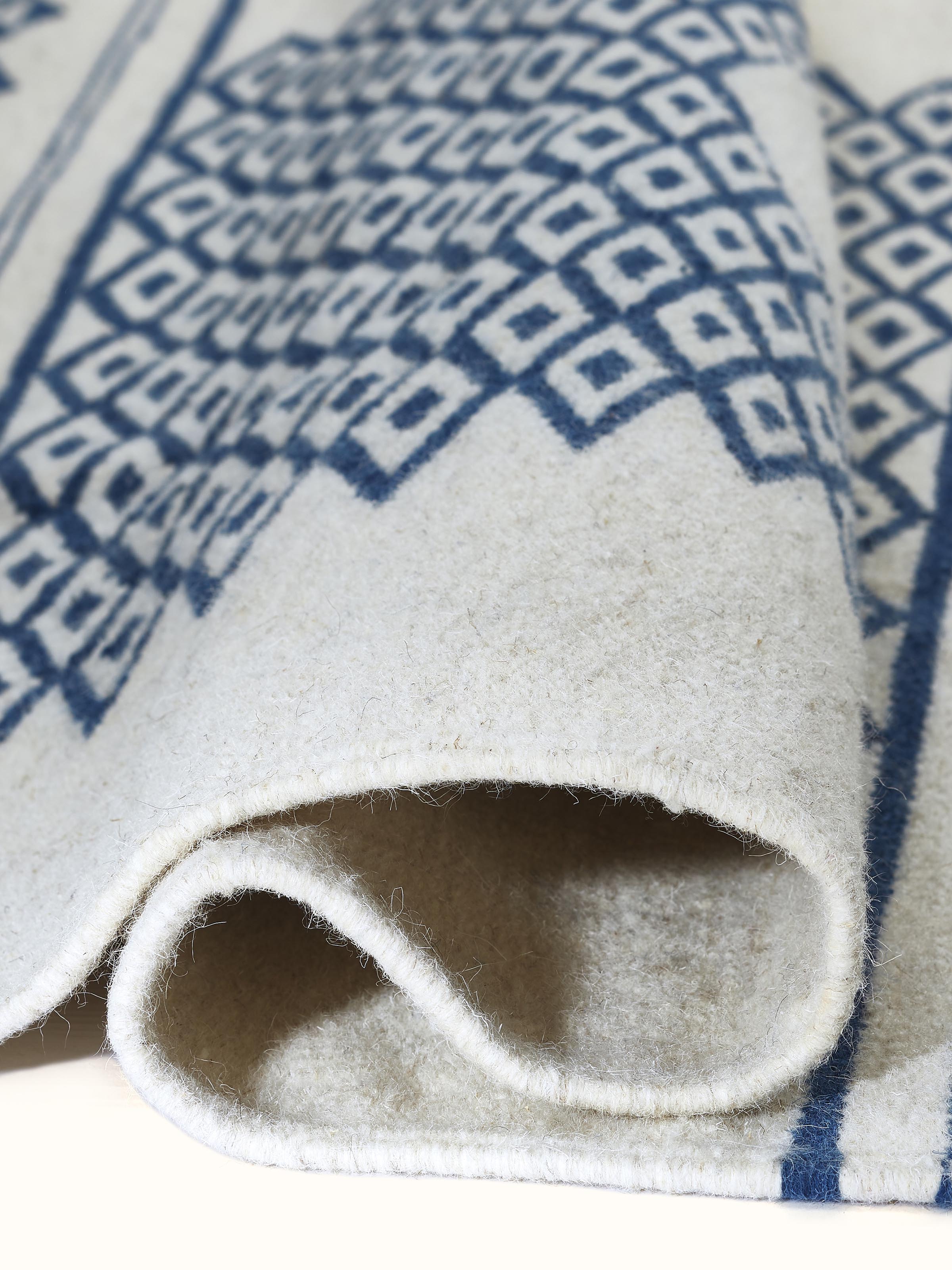 Detailed view of the Traditional Geo Ivory Indigo Gujarat Wool & Cotton Panja Dhurrie Kharad, focusing on the woven pattern.