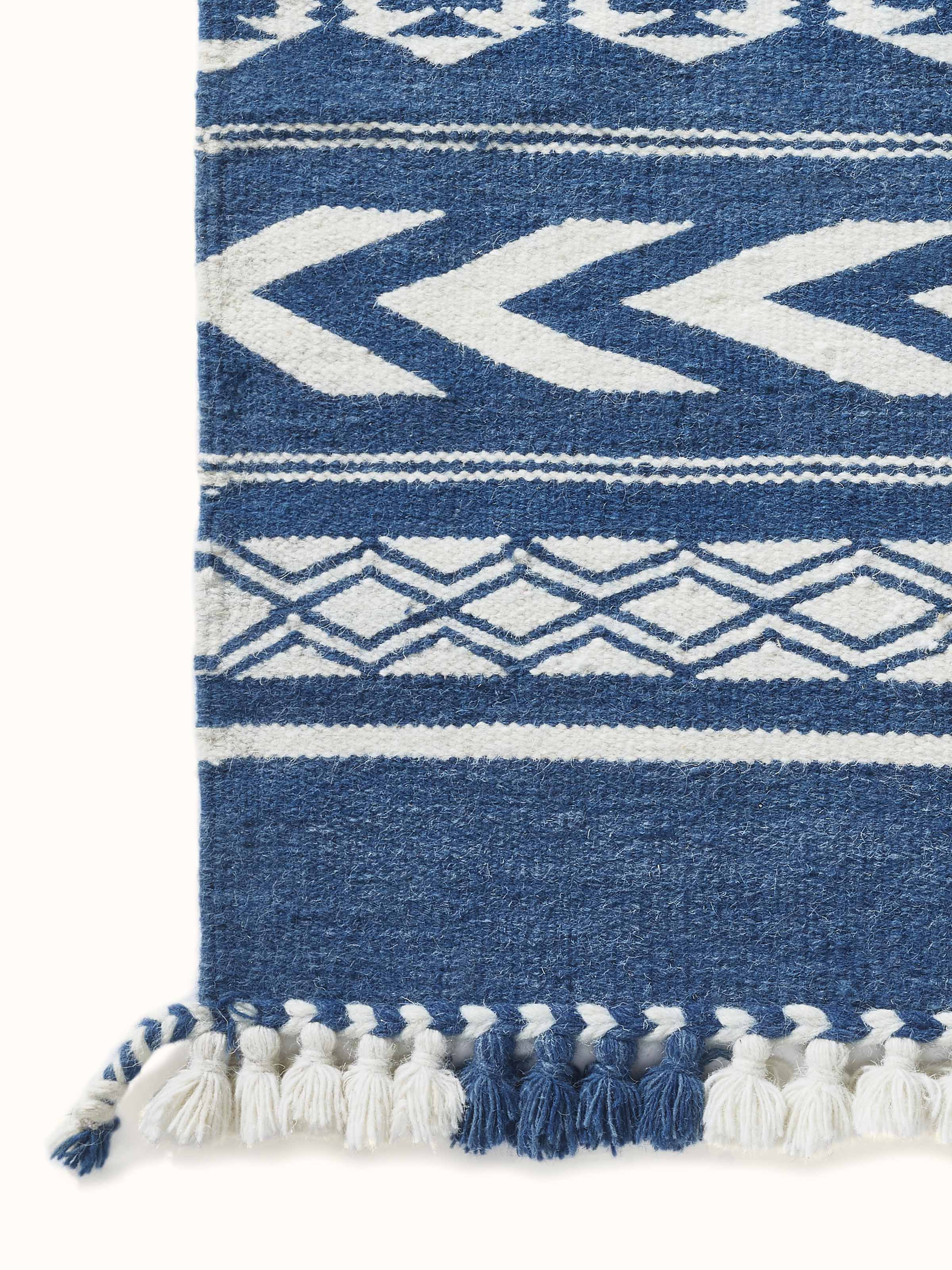 Traditional Geo Indigo Ivory Gujarat wool & cotton panja dhurrie kharad (4x6 ft) displayed on the floor, emphasizing its size and design.