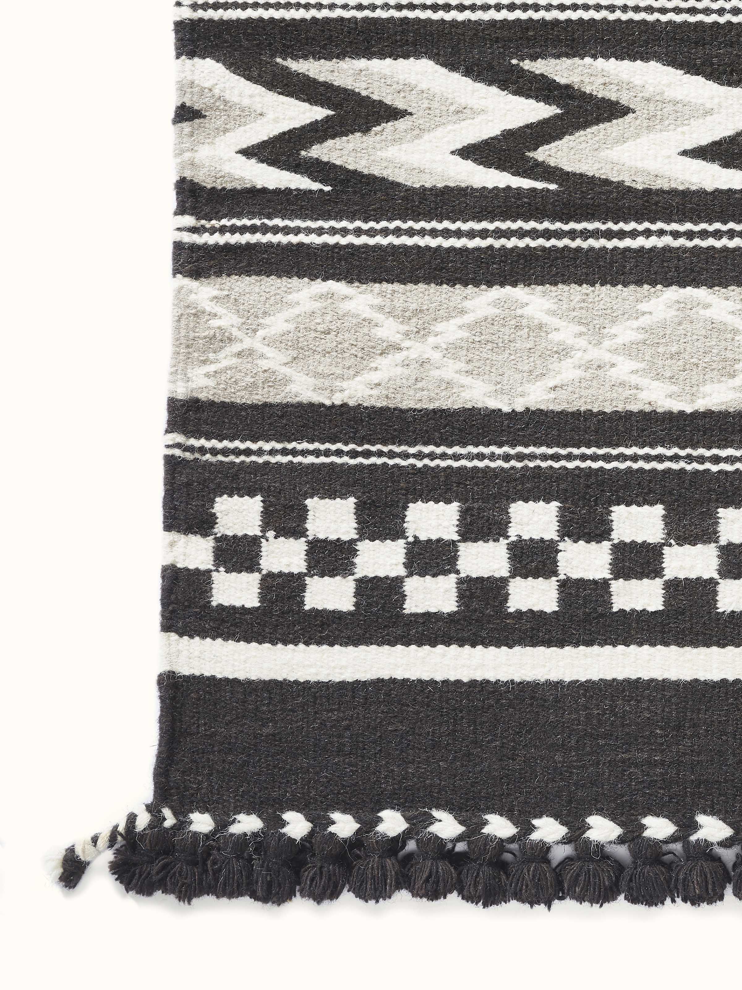 Geo border dark brown Gujarat wool & cotton panja dhurrie kharad (4x6 ft) in a room setting, highlighting its design and functionality