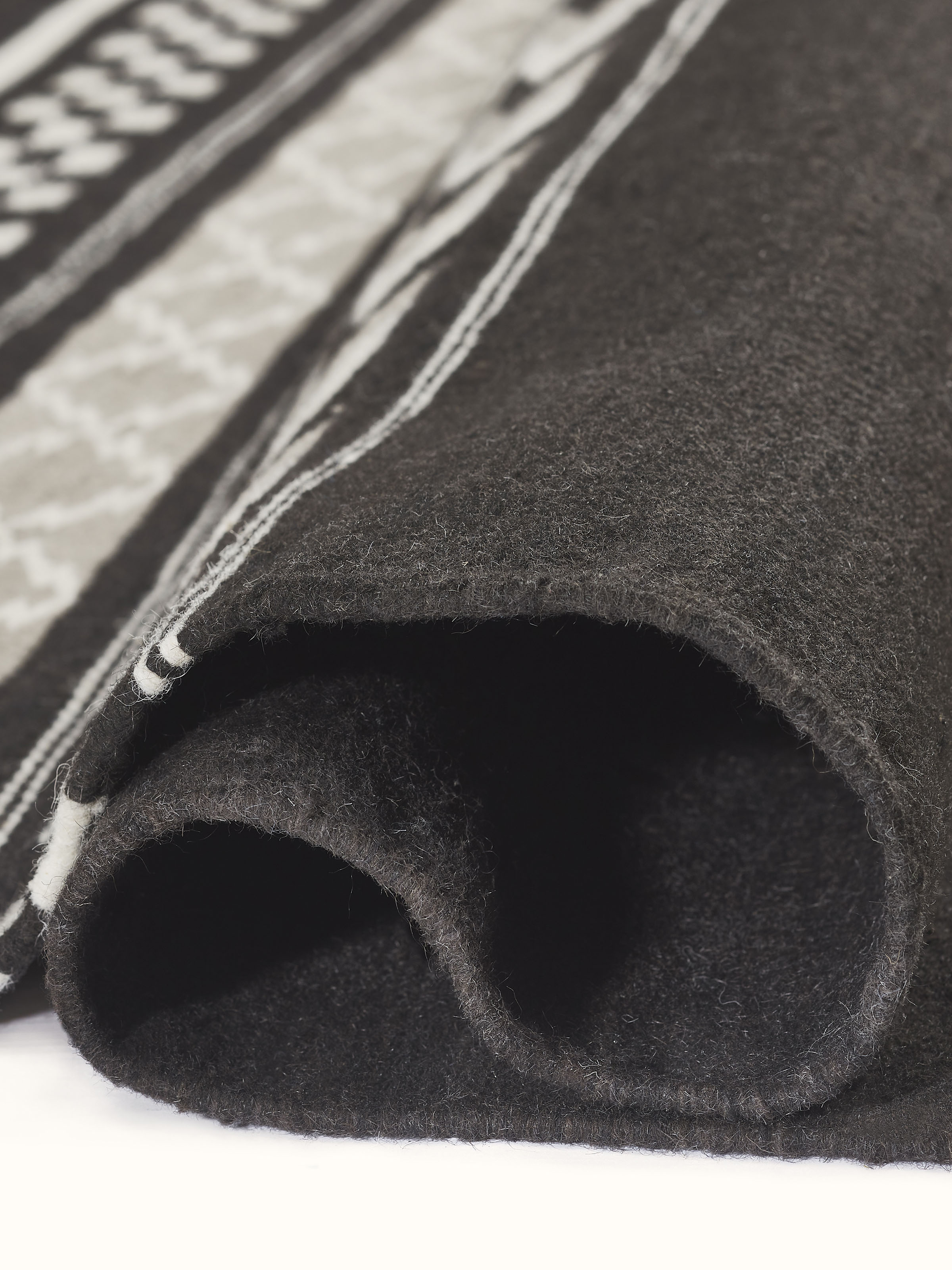 Close-up of Geo border dark brown Gujarat wool & cotton panja dhurrie kharad (4x6 ft), showing the fabric quality and pattern