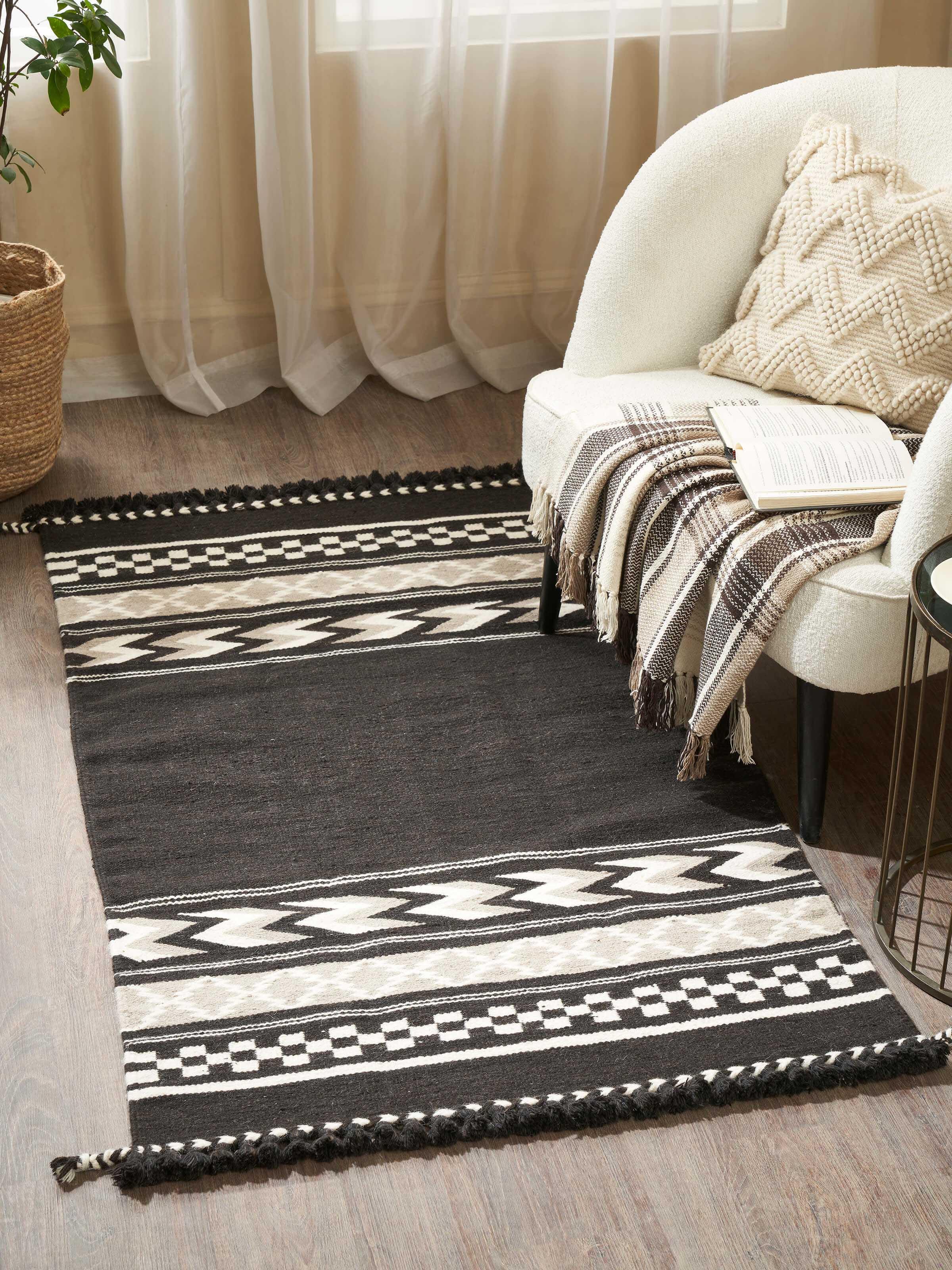 Close-up of Geo border dark brown Gujarat wool & cotton panja dhurrie kharad (3x5 ft) highlighting the texture and border details