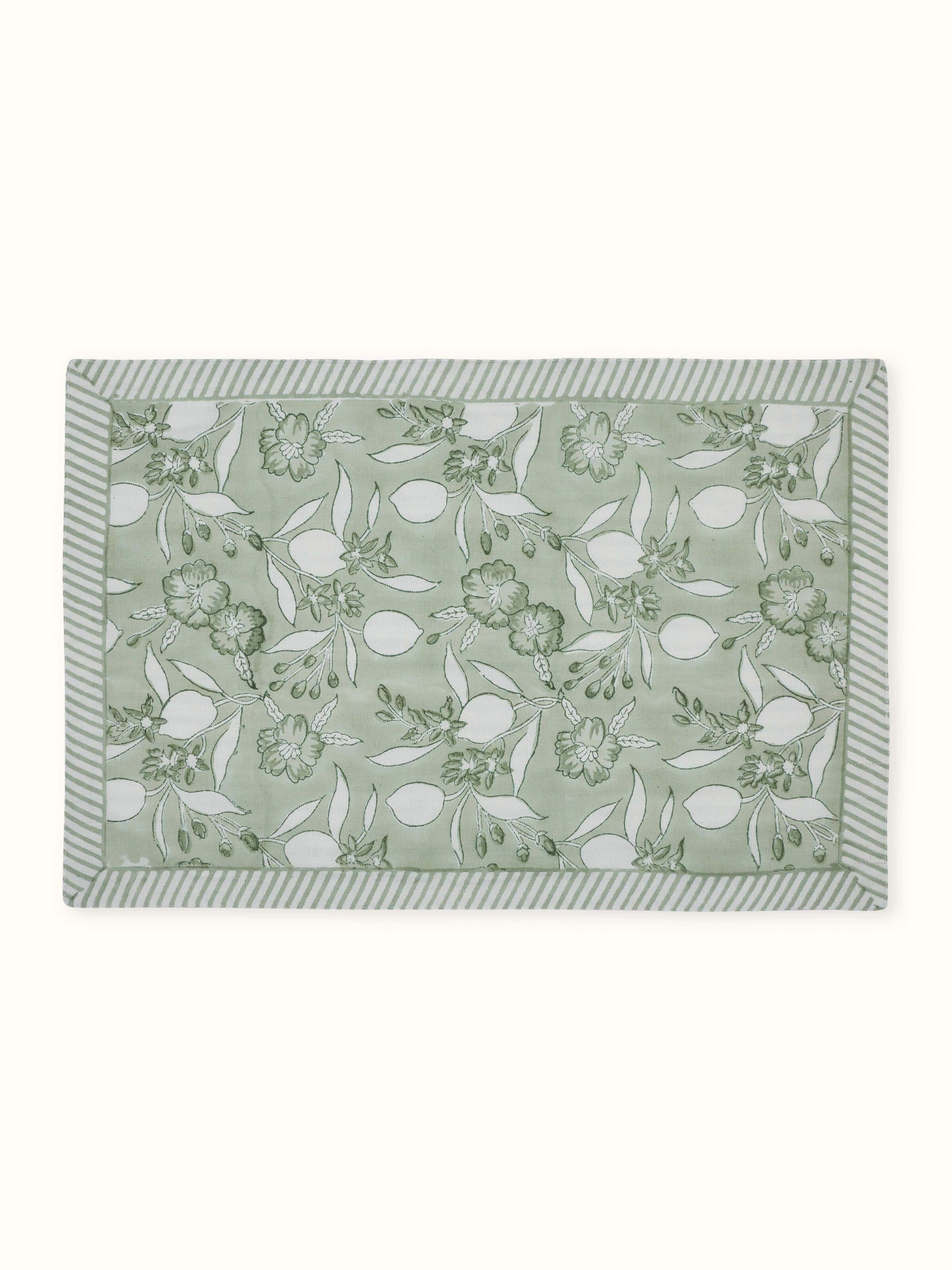 Front view of set of six green floral hand block printed cotton linen table mats.