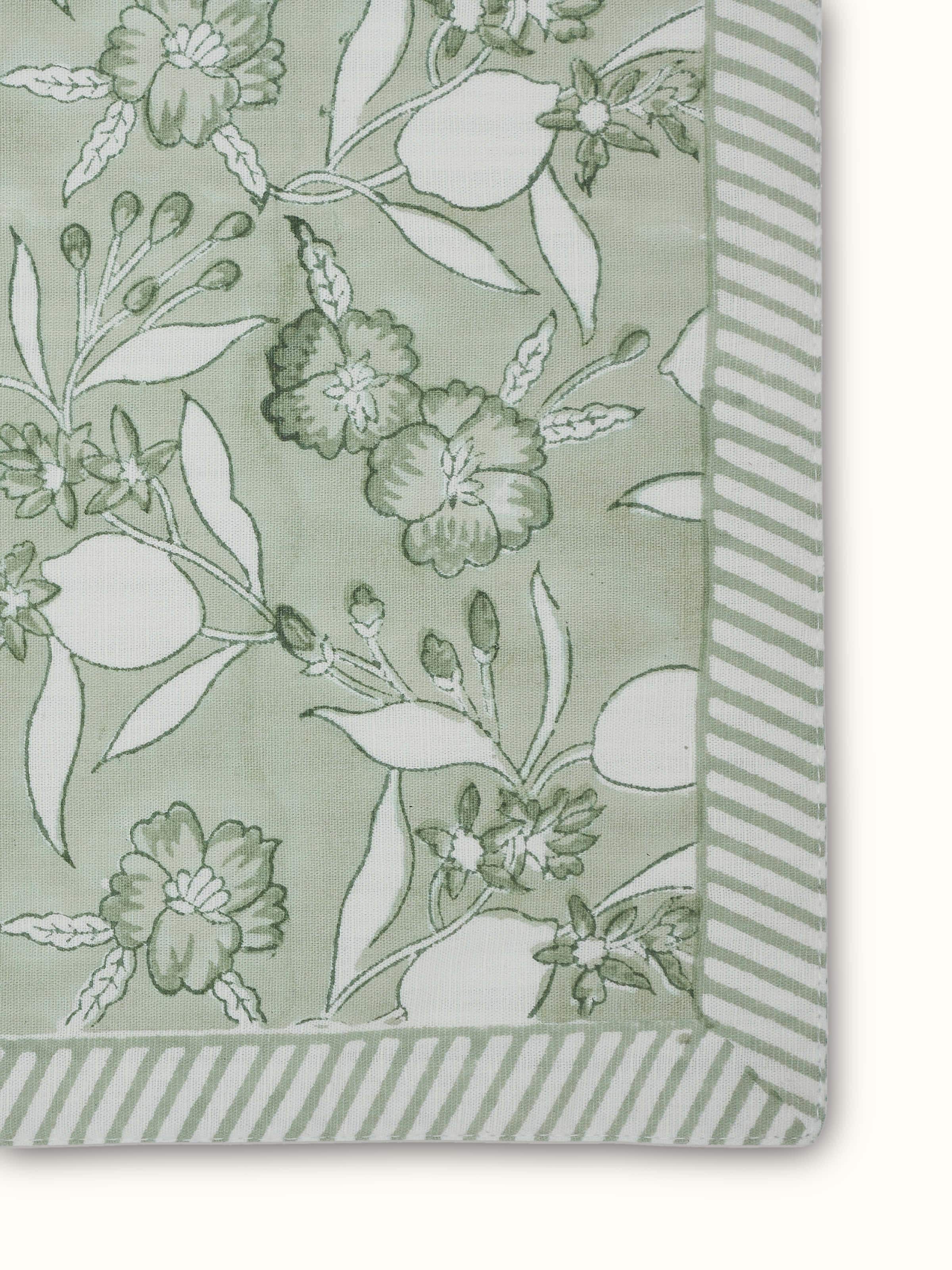 Angled view capturing hand block print detail and textured linen fabric.