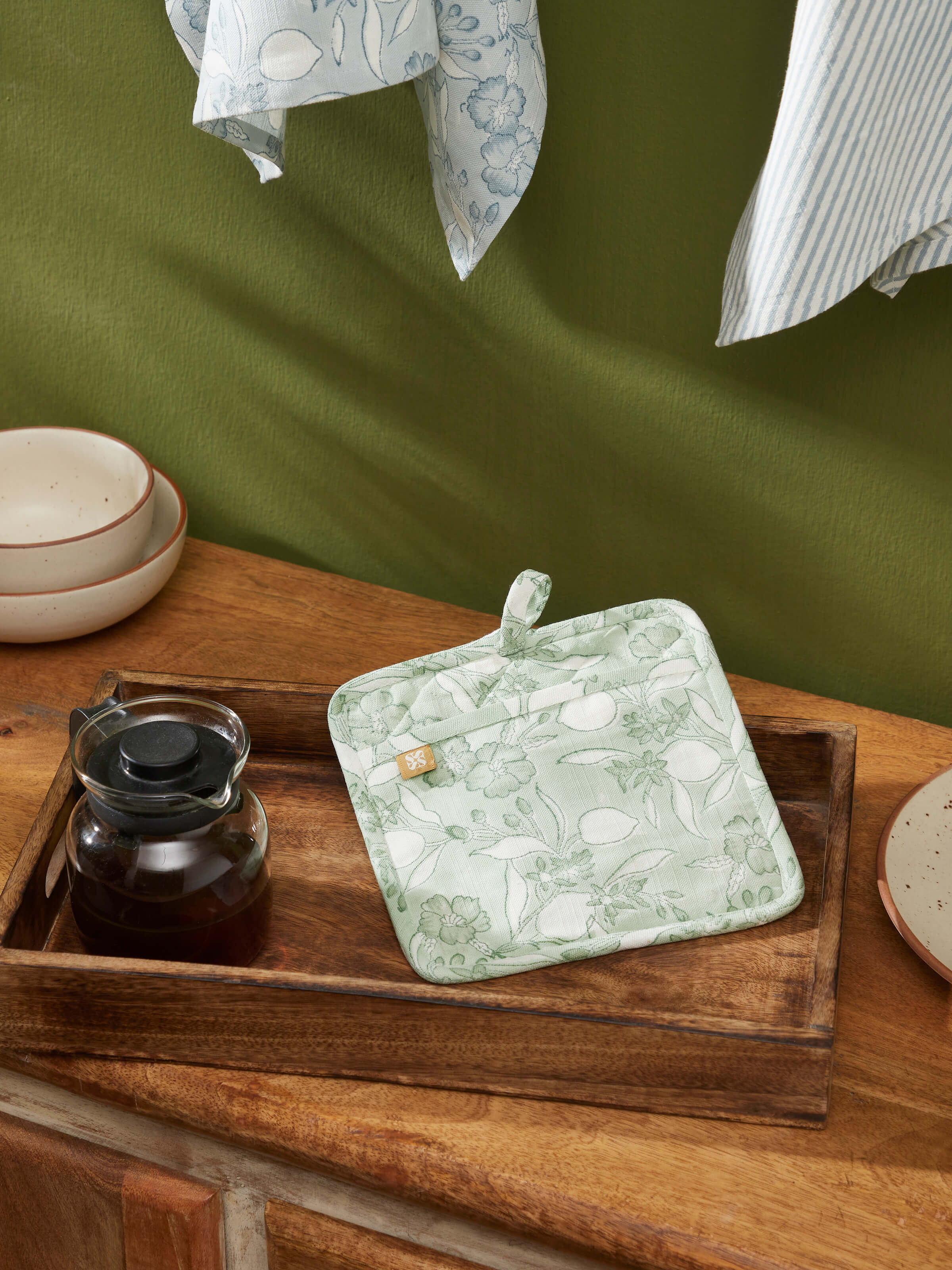 Close-up view of Anika green floral cotton Sanganeri block printed pot holder highlighting the floral block print and cotton fabric.