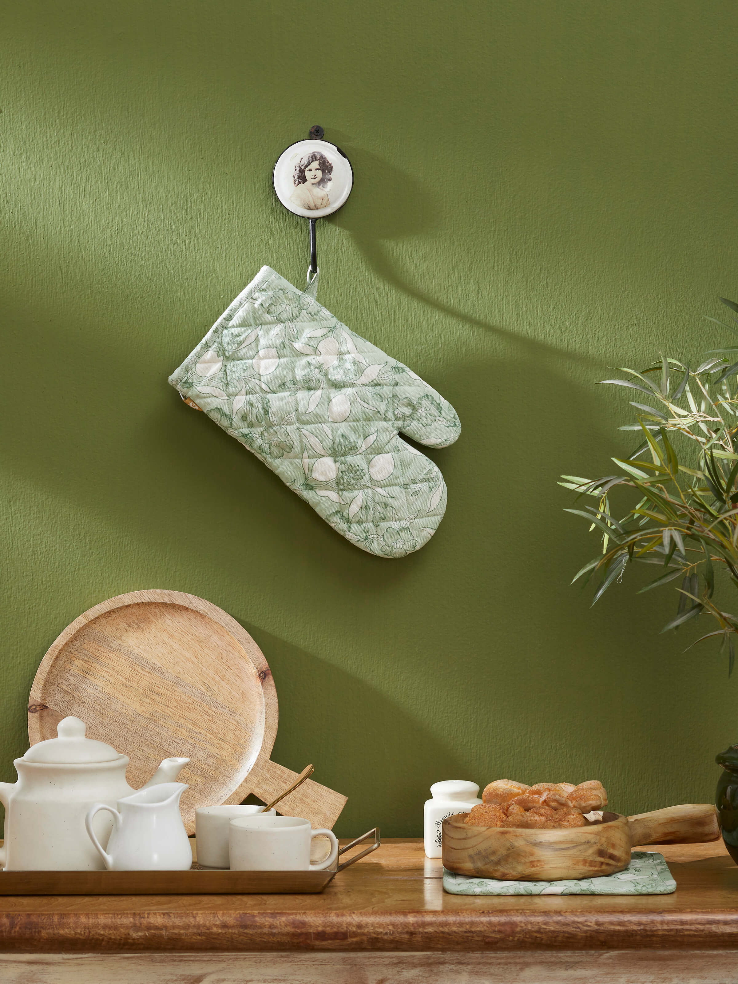 Close-up of green floral cotton Sanganeri block printed oven mitts showing the detailed block printing.