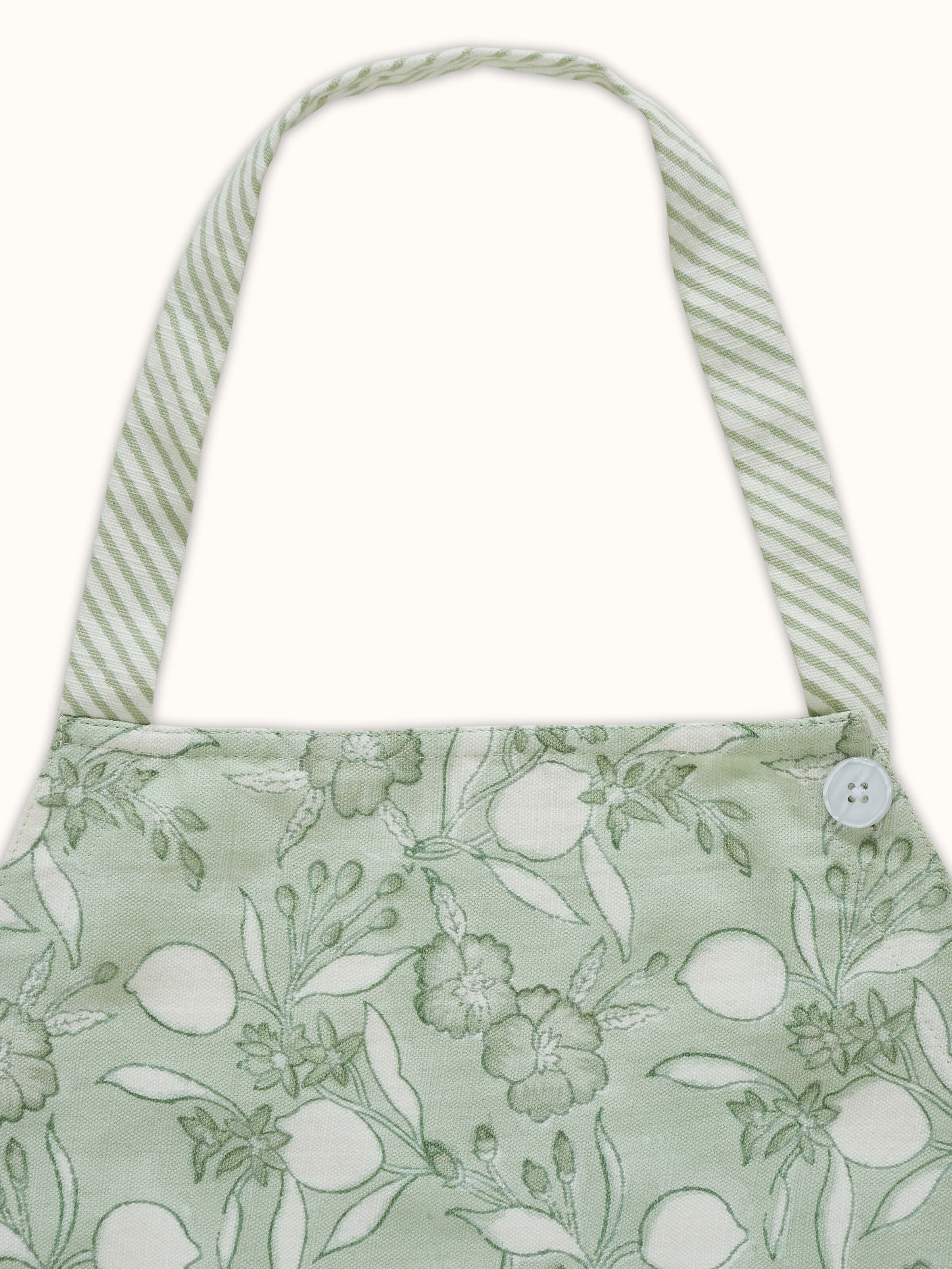 Green floral cotton Sanganeri block printed apron displayed with its full pattern and design visible.