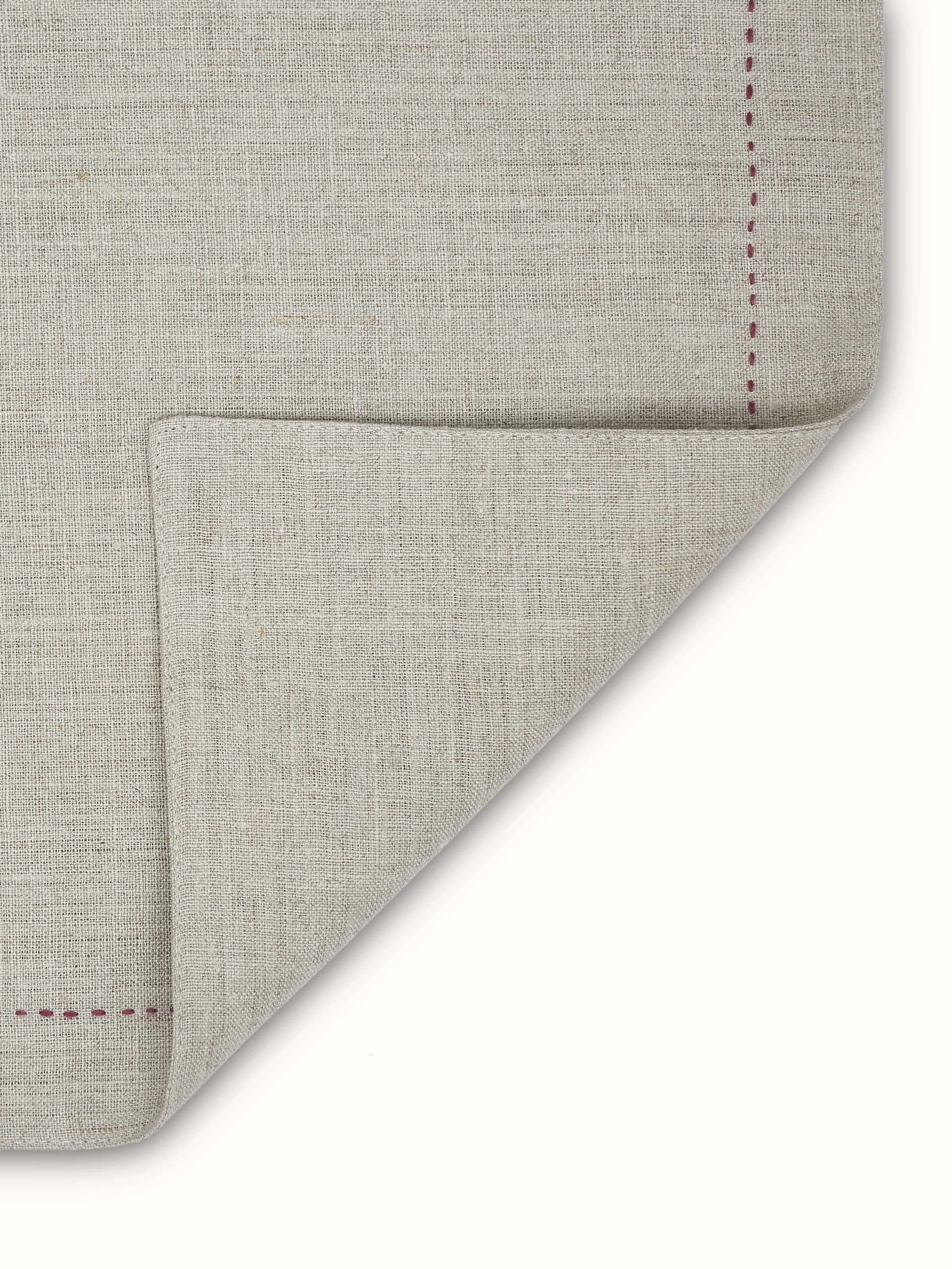 Back view of solid beige linen mats showing quality stitching and plain finish.
