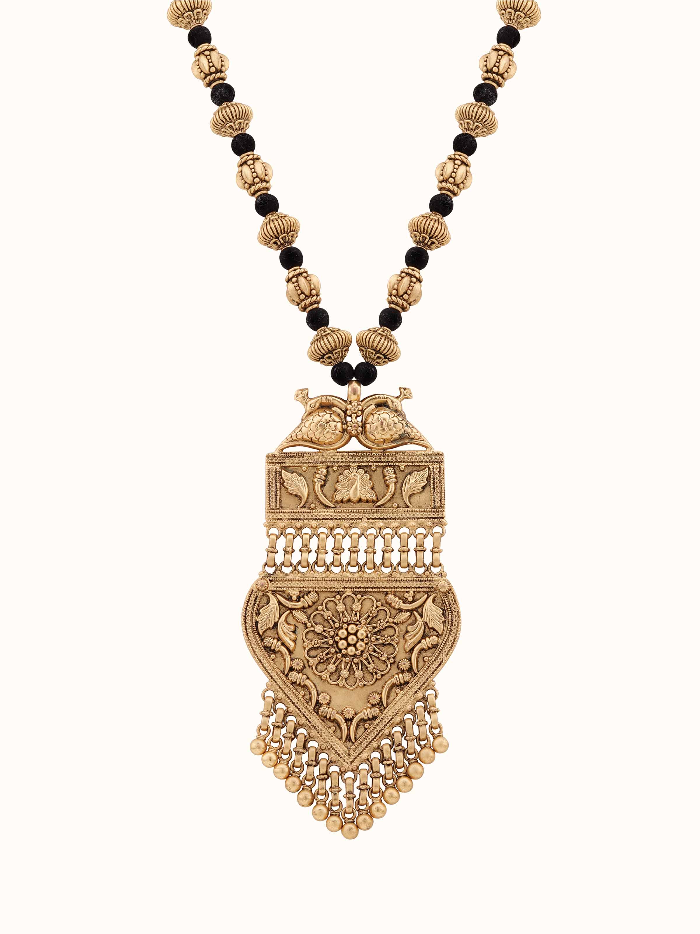 Front view of silversmithing long necklace highlighting detailed metalwork.