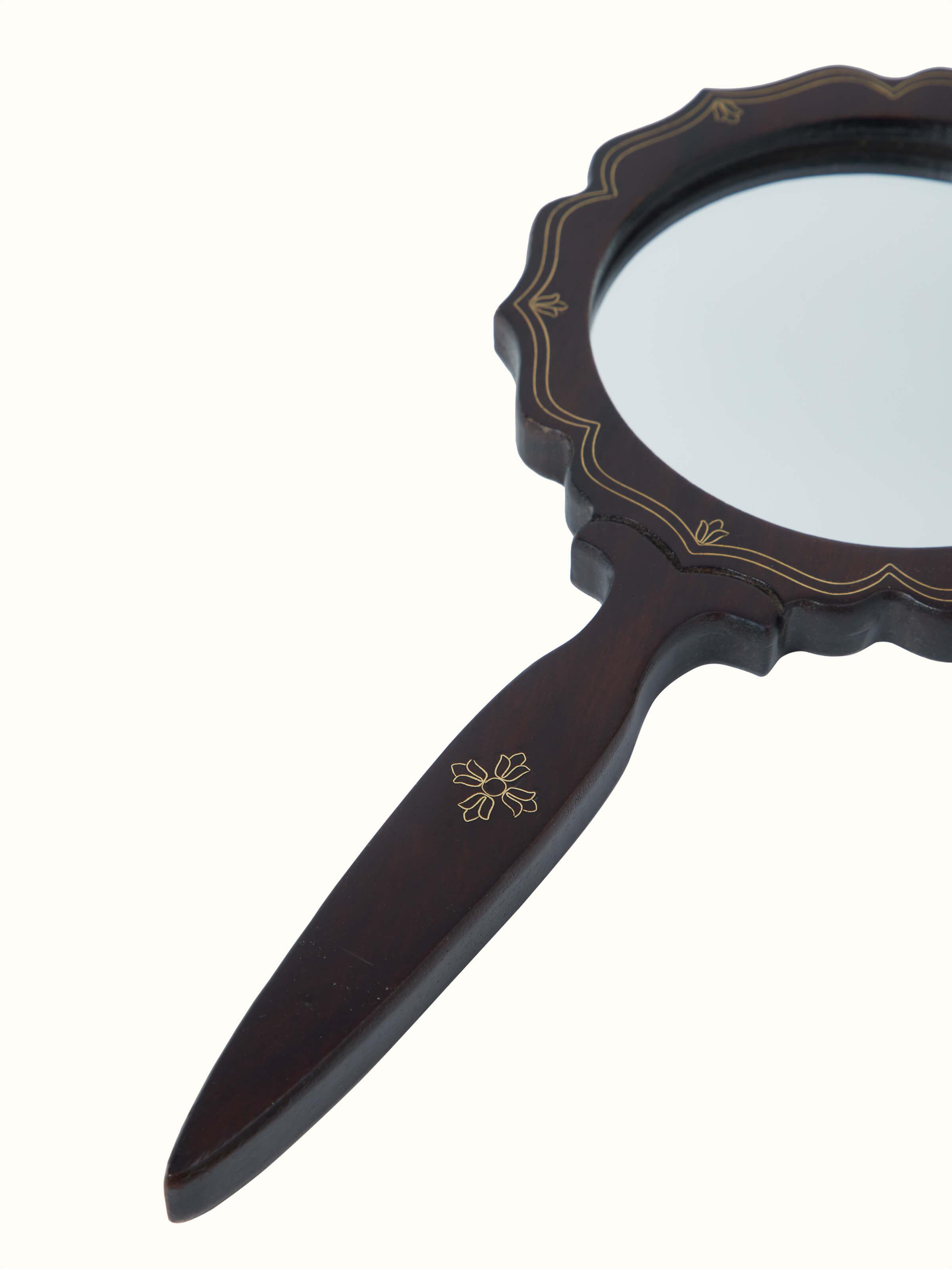 Close-up view of Tarkashi sheesham wood & brass inlaid mirror in brown color, focusing on the detailed craftsmanship.