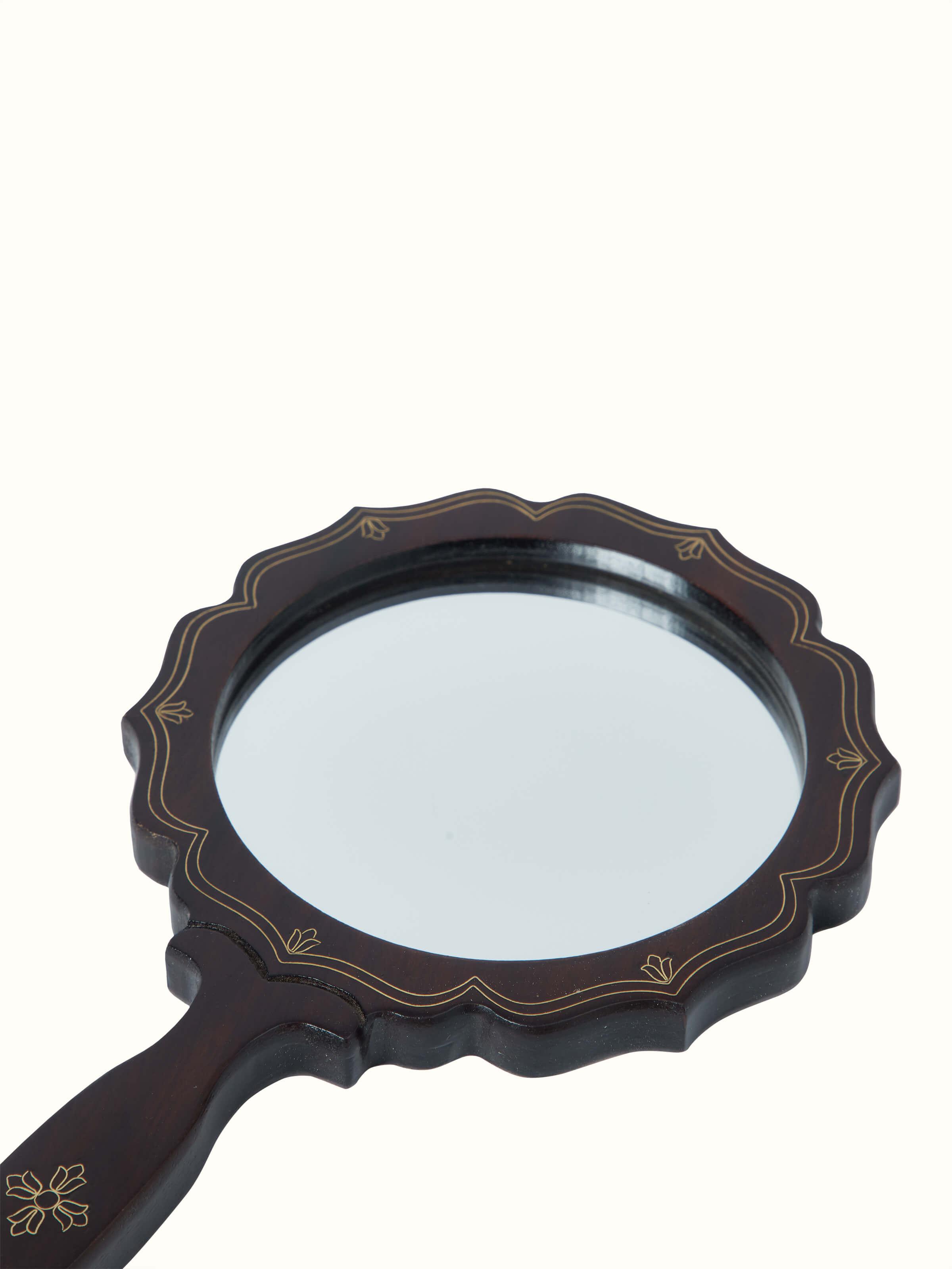Detailed view of Tarkashi sheesham wood & brass inlaid mirror in brown color, highlighting the elegant wood and brass details.
