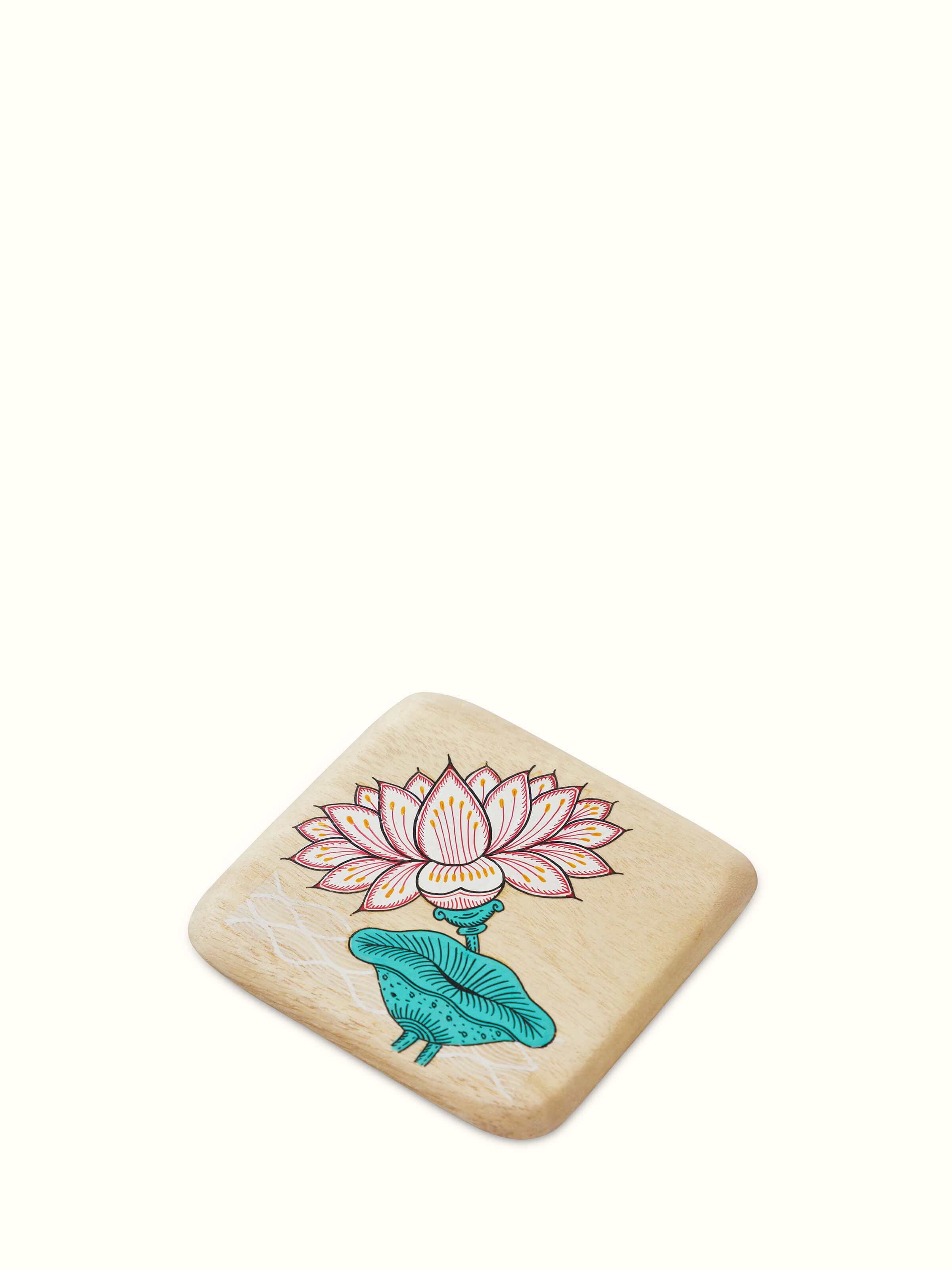 Top view of the carved gamhar wood coasters in white and teal, highlighting their decorative design and finish.