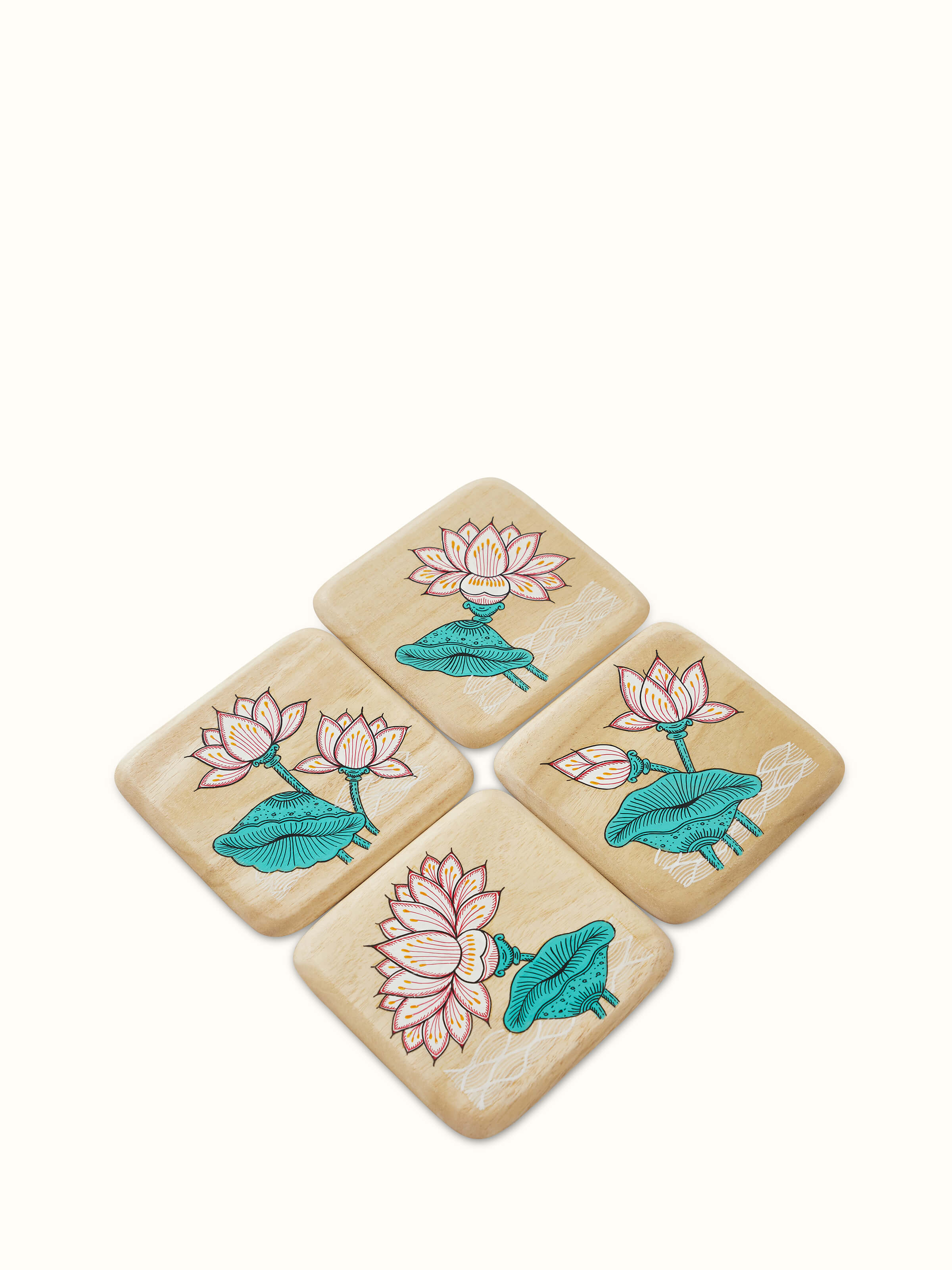 Set of four carved gamhar wood coasters in white and teal, featuring intricate patterns and elegant design.