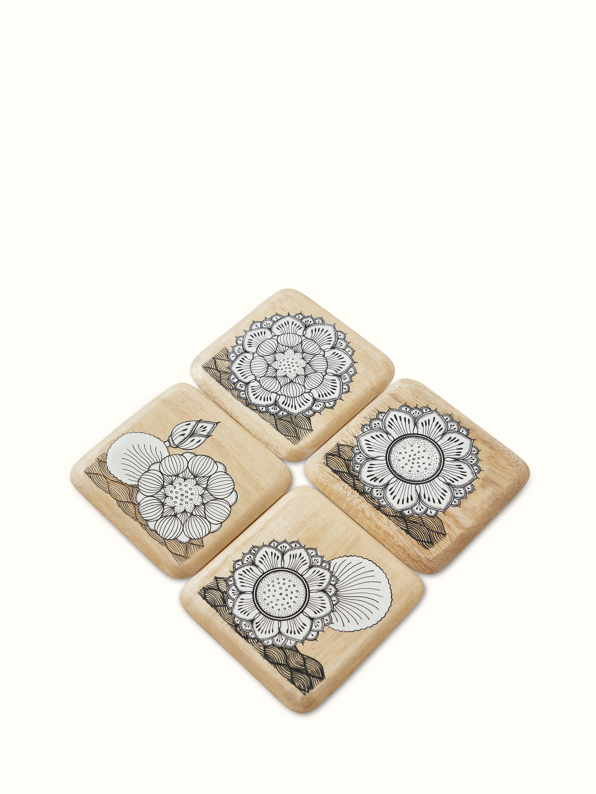 Front view of Carved Gamhar Wood Coasters in White & Black (4 pcs) showcasing detailed carving