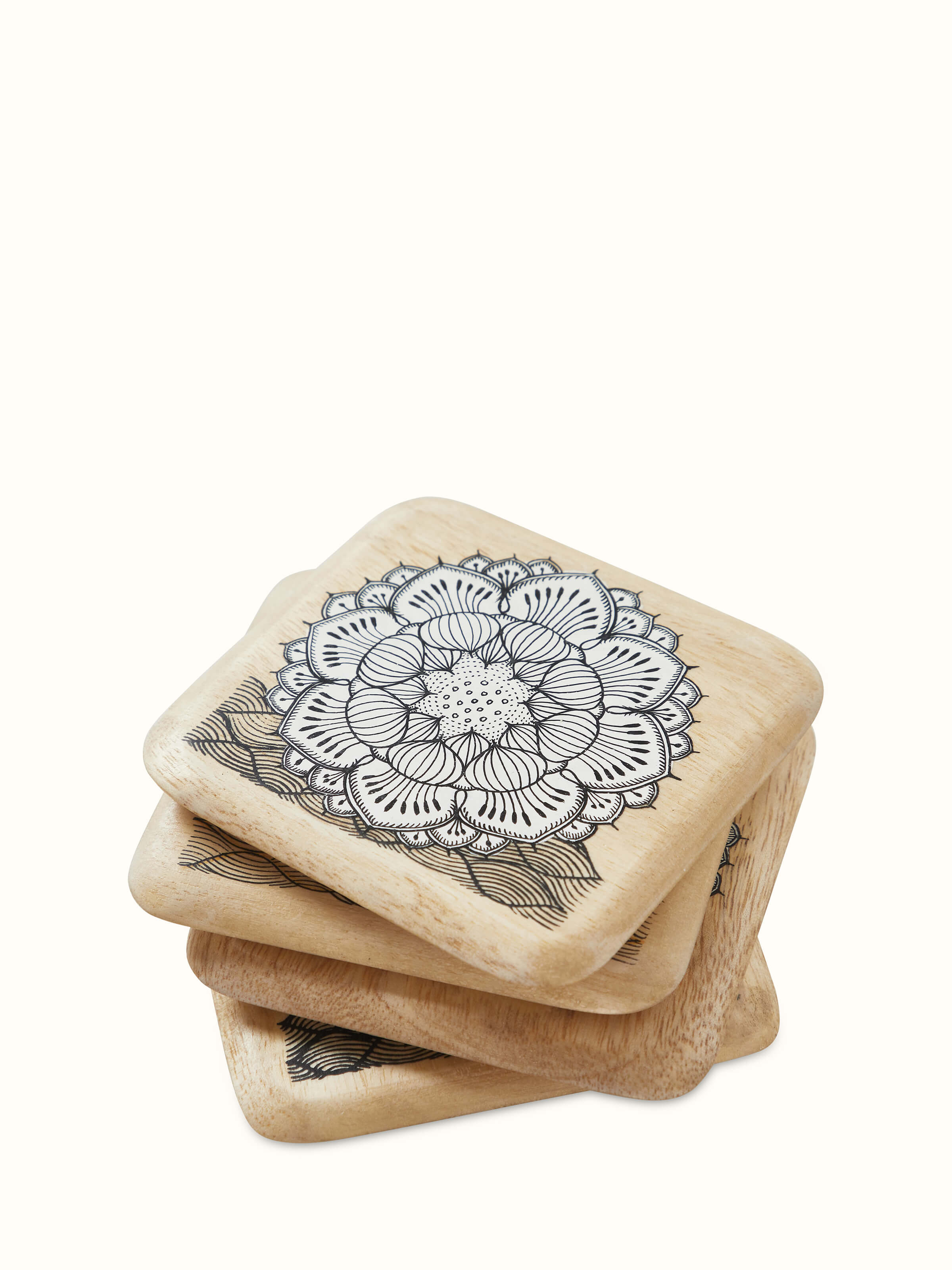 Angled view of Carved Gamhar Wood Coasters in White & Black (4 pcs) emphasizing the elegance