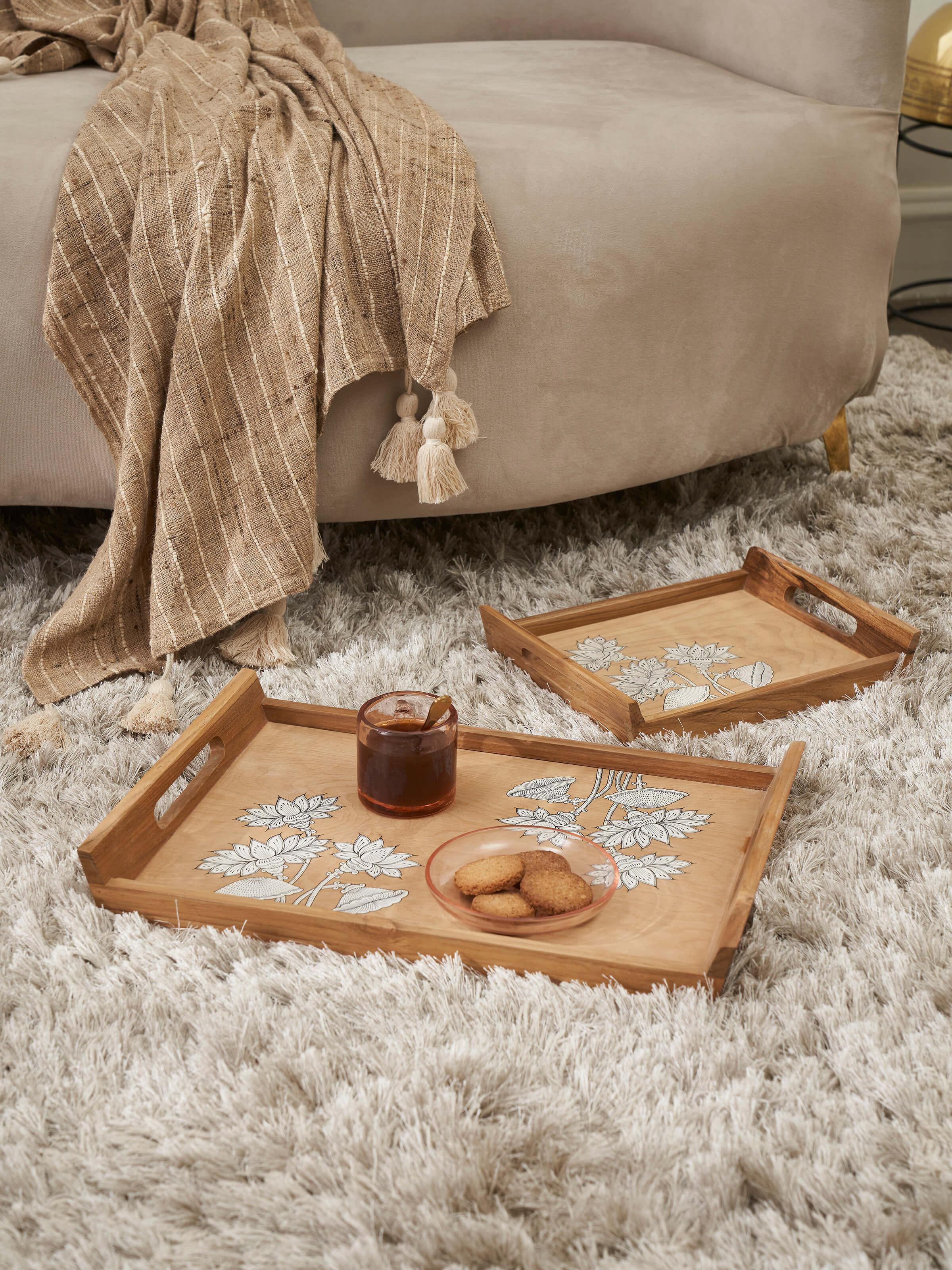 Side view of Carved teak wood trays in brown (2 pcs) highlighting the intricate carvings and finish