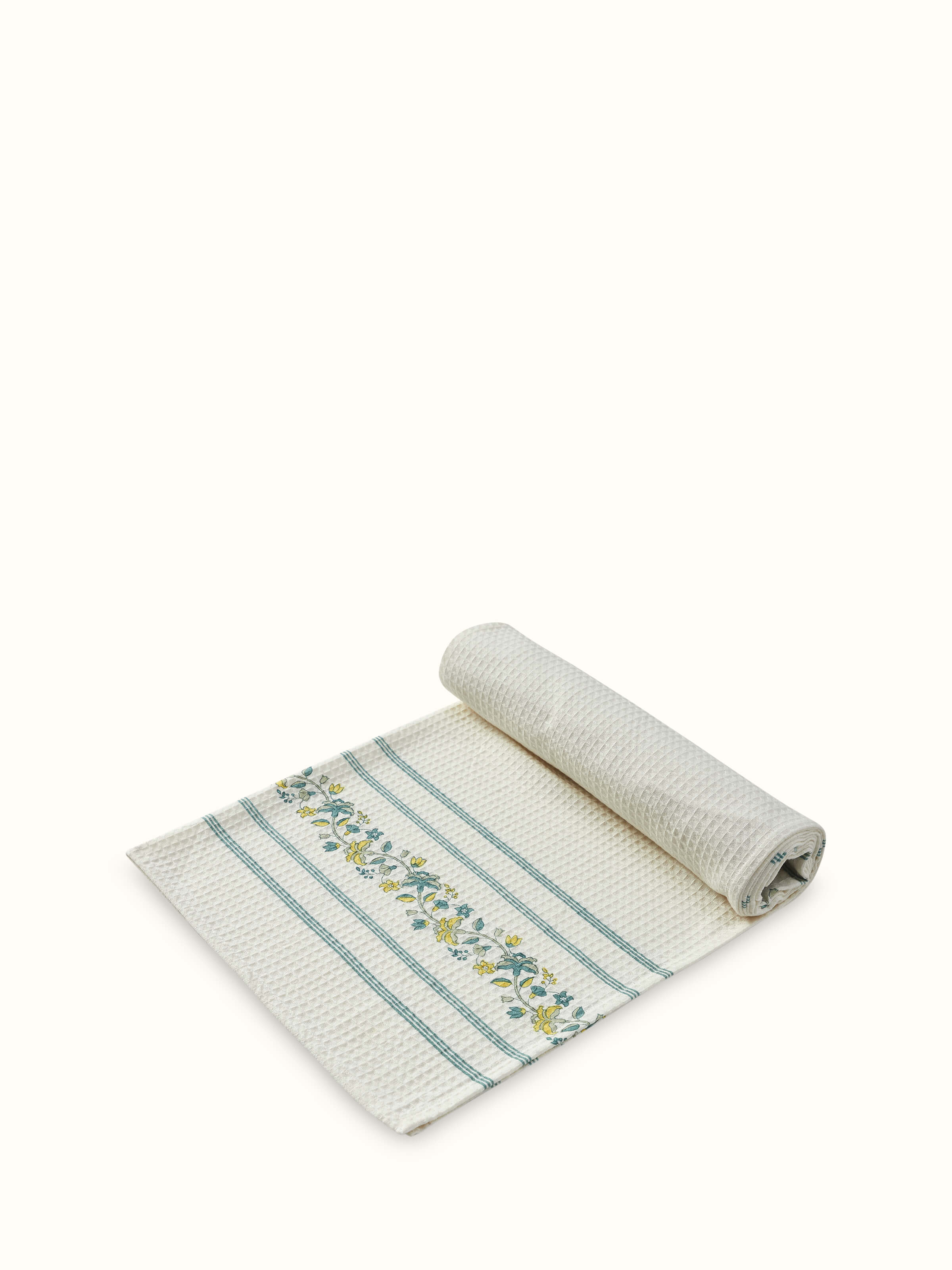 Detailed view of Palampore stripe yellow floral cotton Sanganeri block printed bath towel (L) showing the fabric and pattern.