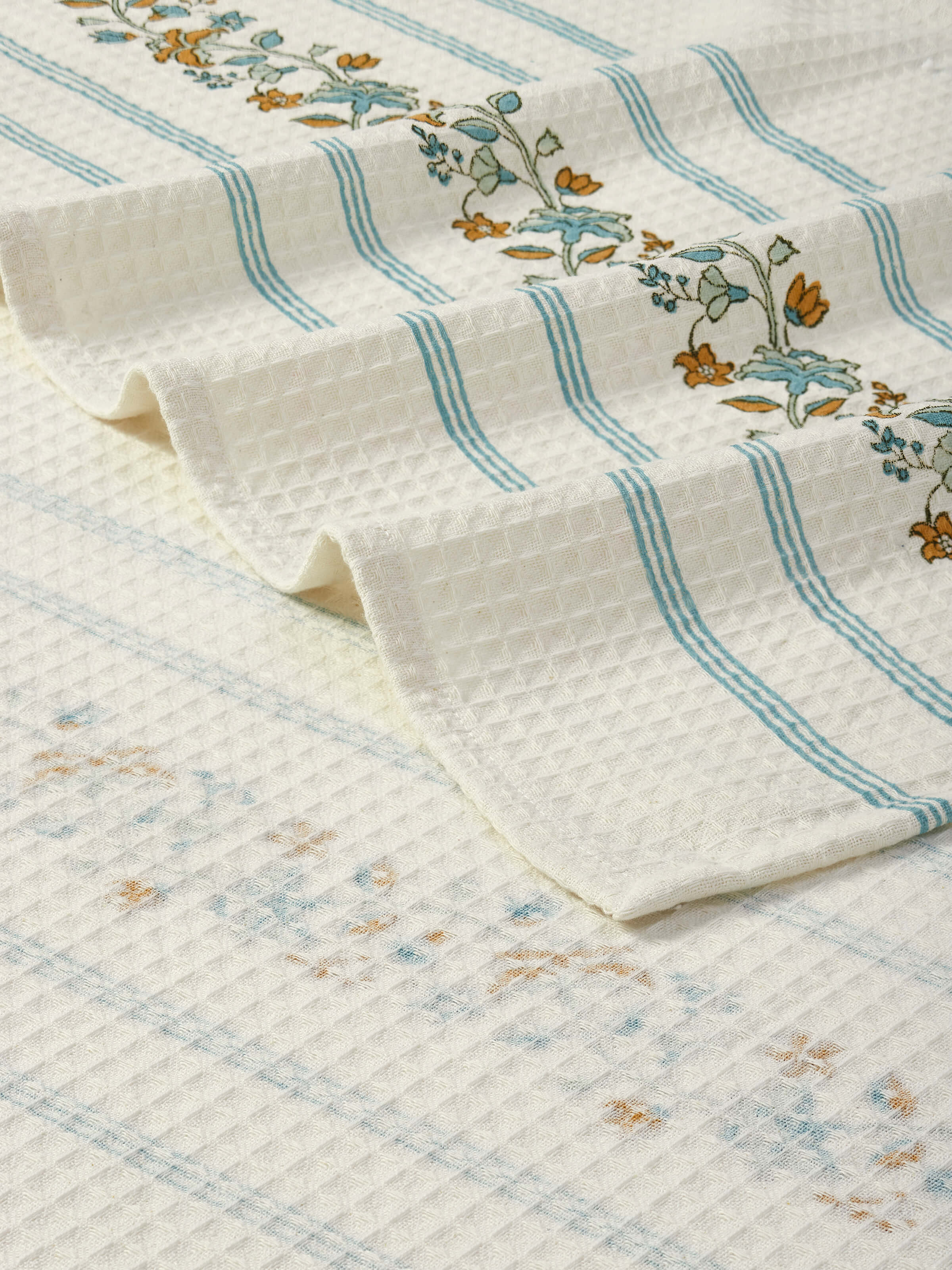 Angled view of Palampore Stripe White Floral Cotton Sanganeri Block Printed Bath Towel (XL), displaying its full length and print design.