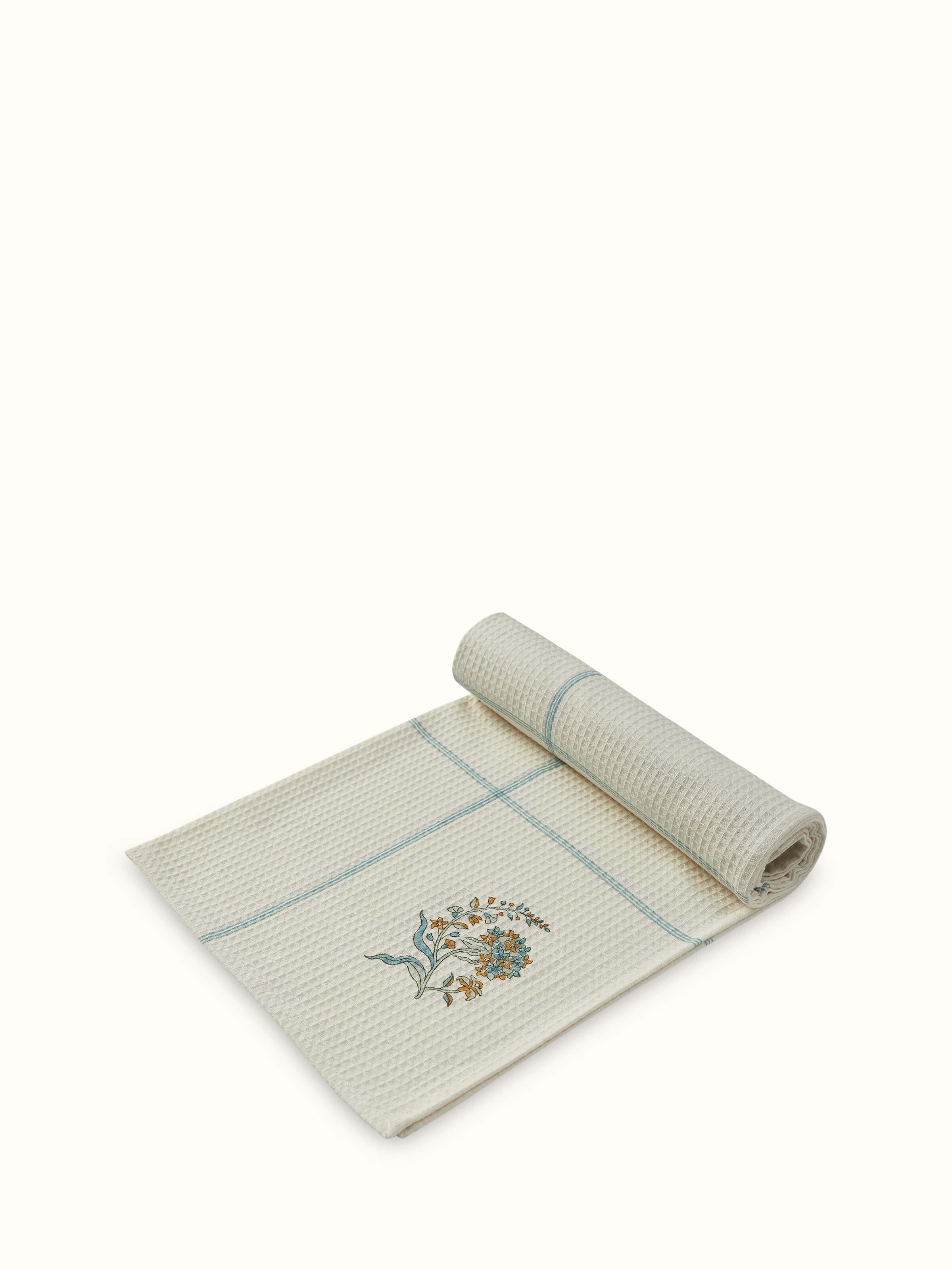Palampore white floral cotton bath towel draped to display the full block printed pattern and design.