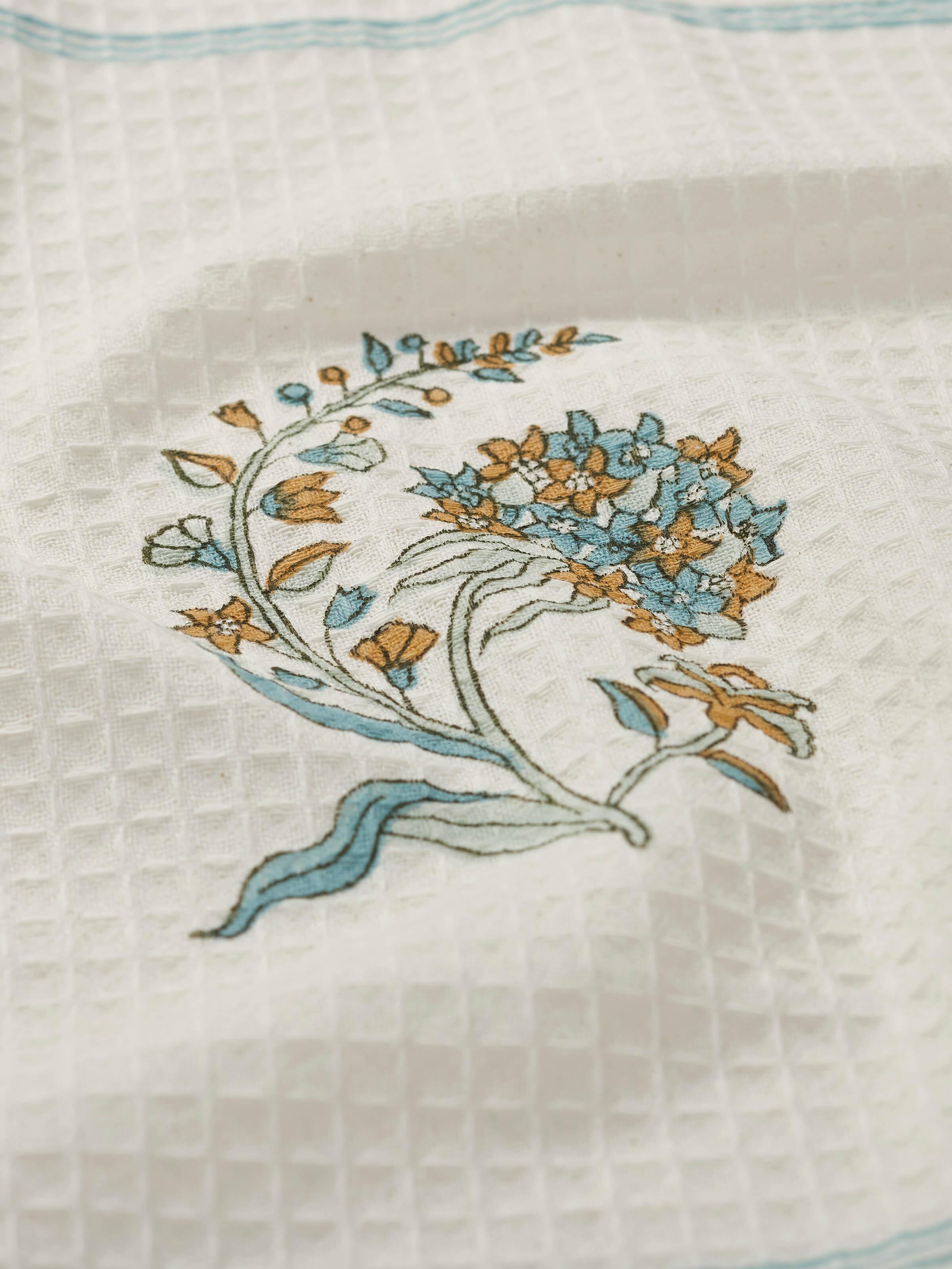 Detailed view of Palampore white floral bath towel, focusing on the texture and block print design.