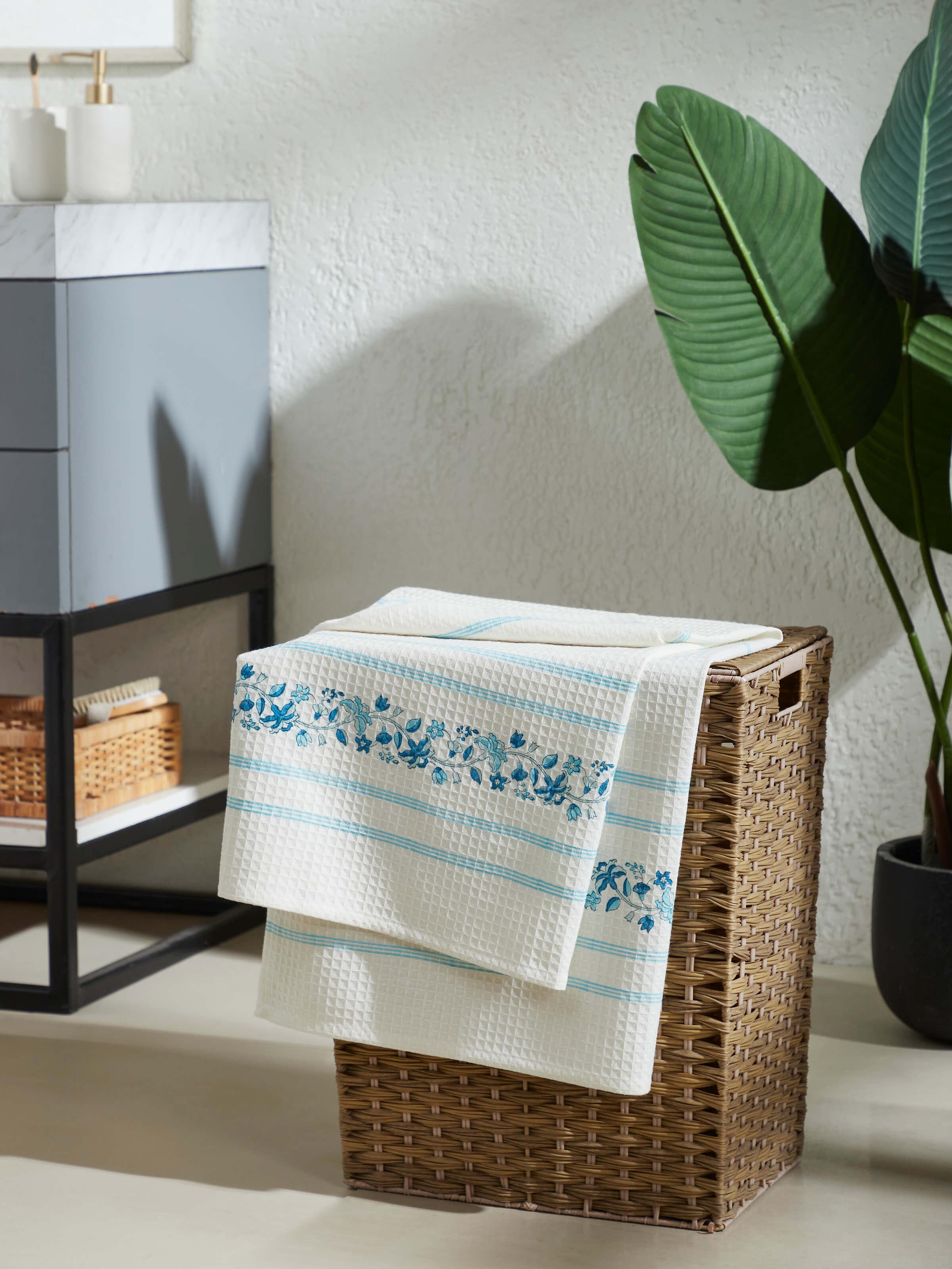 Close-up of Palampore blue floral cotton bath towel featuring stripe and block print details