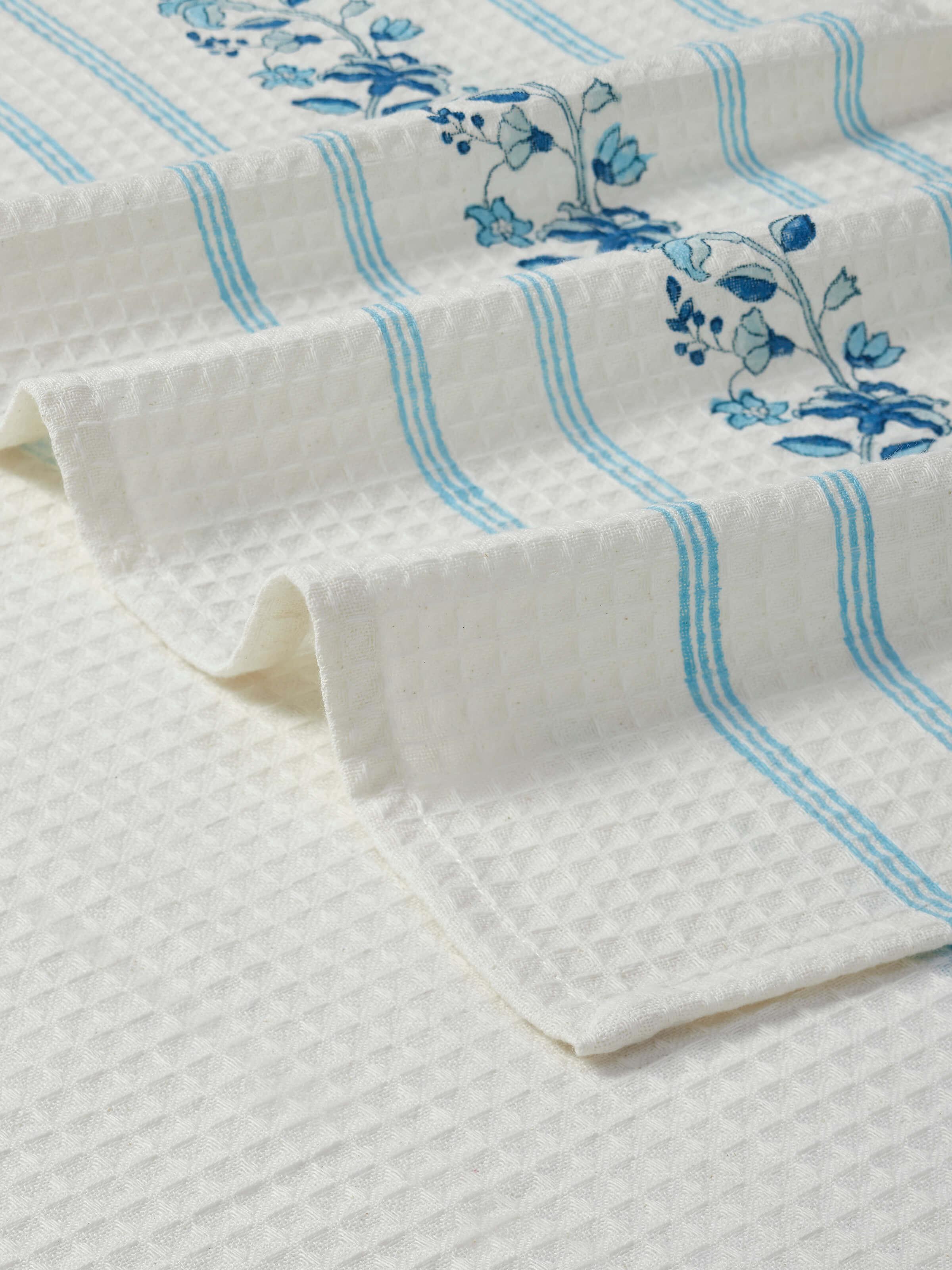 Full view of Palampore blue floral bath towel highlighting the stripe and block print design