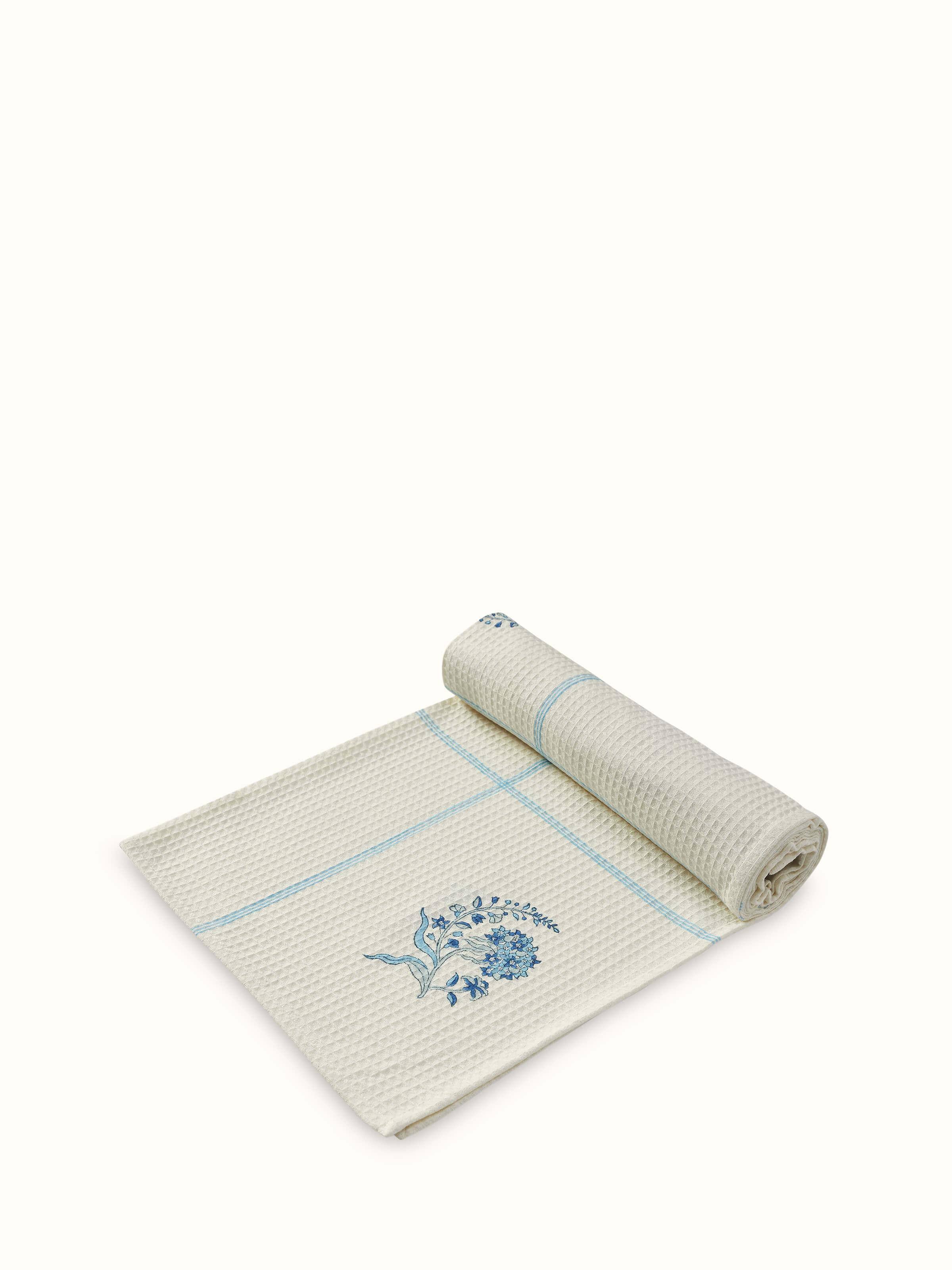 Side view of Palampore Buta blue floral cotton Sanganeri block printed bath towel (L) showing the design and fabric quality of the towel.