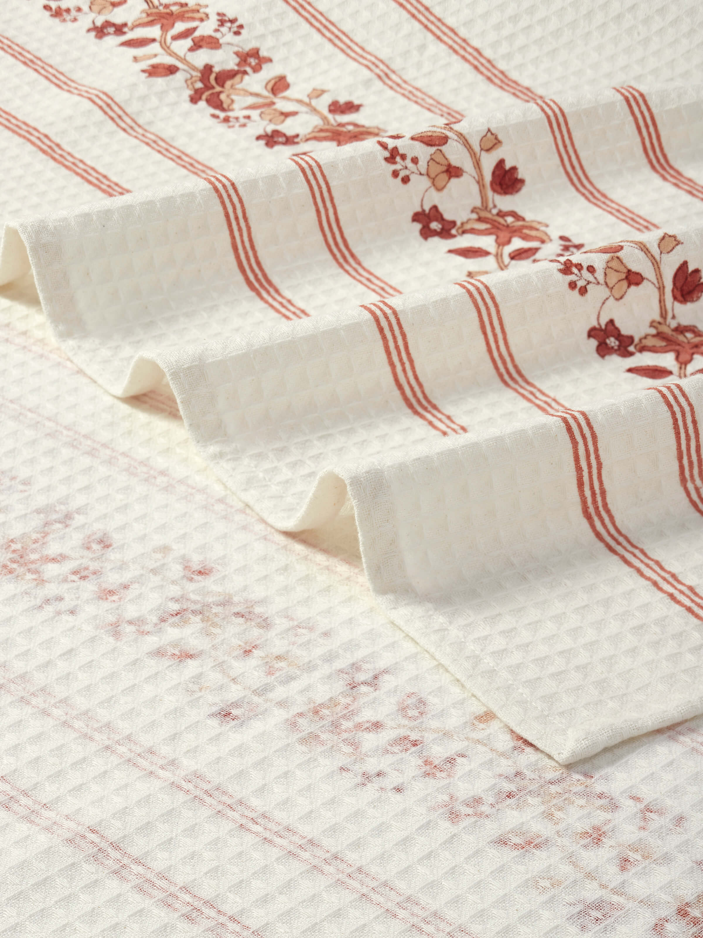 Palampore stripe peach floral cotton Sanganeri block printed bath towel (XL) on a towel rack, emphasizing its design and size.