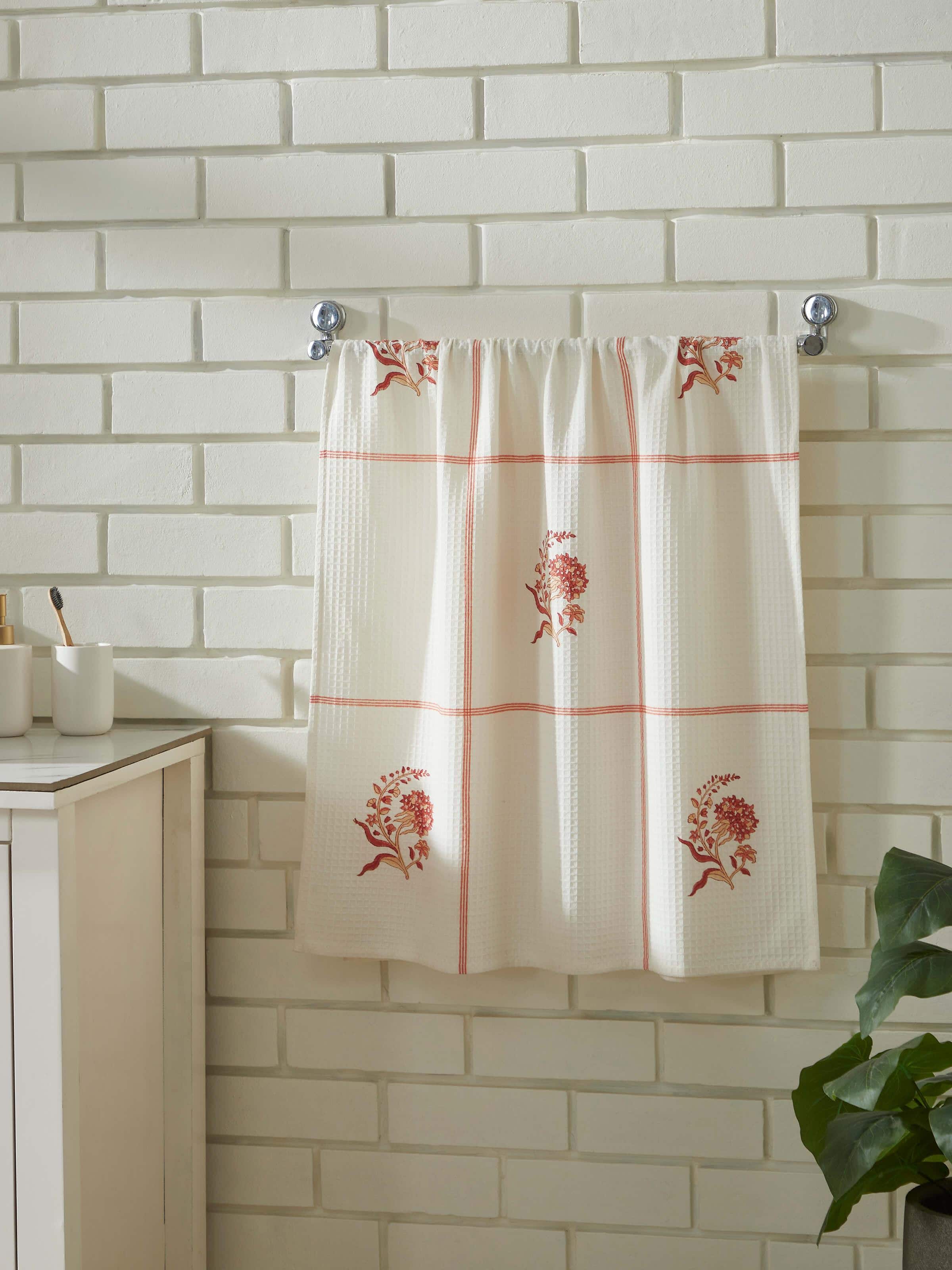 Close-up of Palampore buta peach floral cotton Sanganeri block printed bath towel (L) highlighting the intricate block print details and floral design.