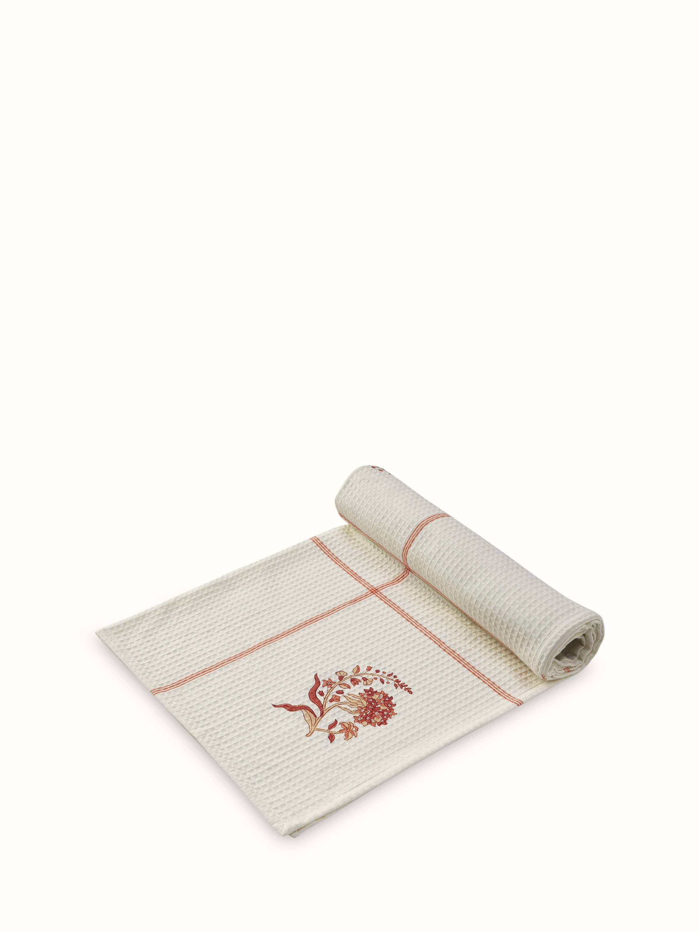 Side view of Palampore buta peach floral cotton Sanganeri block printed bath towel (L) displaying the towel's design and print quality.