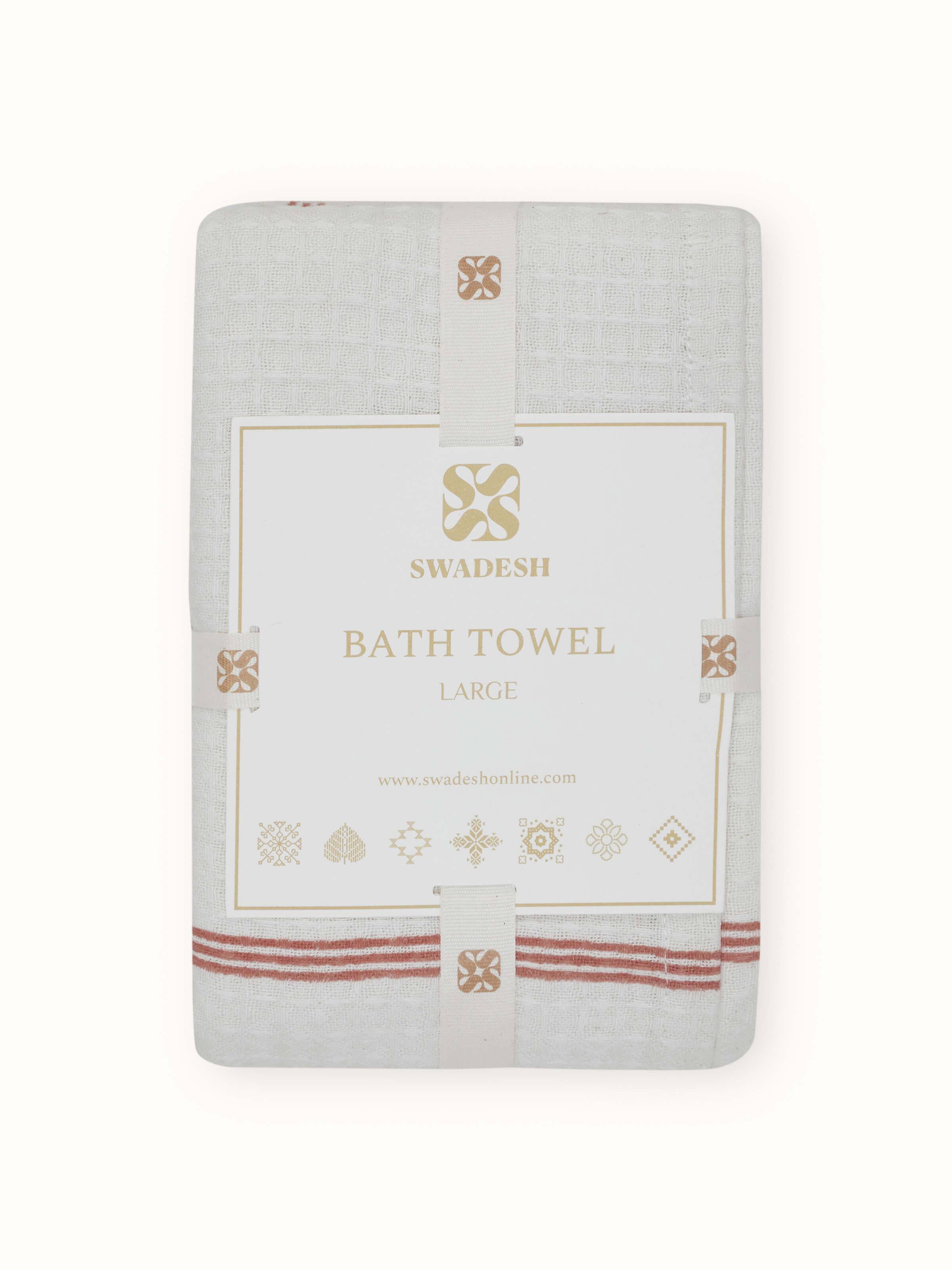 Perspective view of Palampore buta peach floral cotton Sanganeri block printed bath towel (L) capturing its overall design and print pattern.