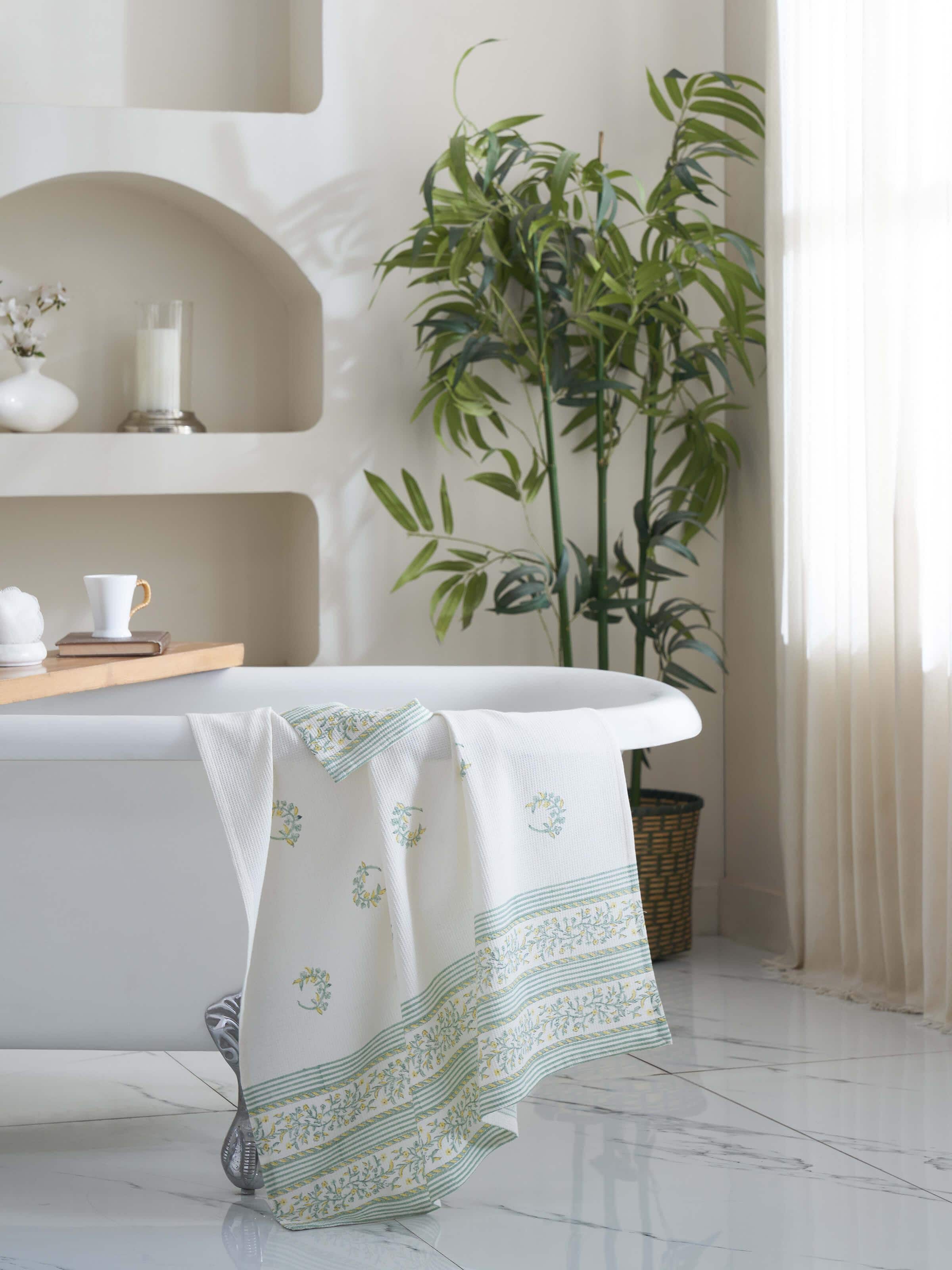 Close-up of Ambi allover yellow floral cotton Sanganeri block printed bath towel (L) highlighting the intricate floral block print details.