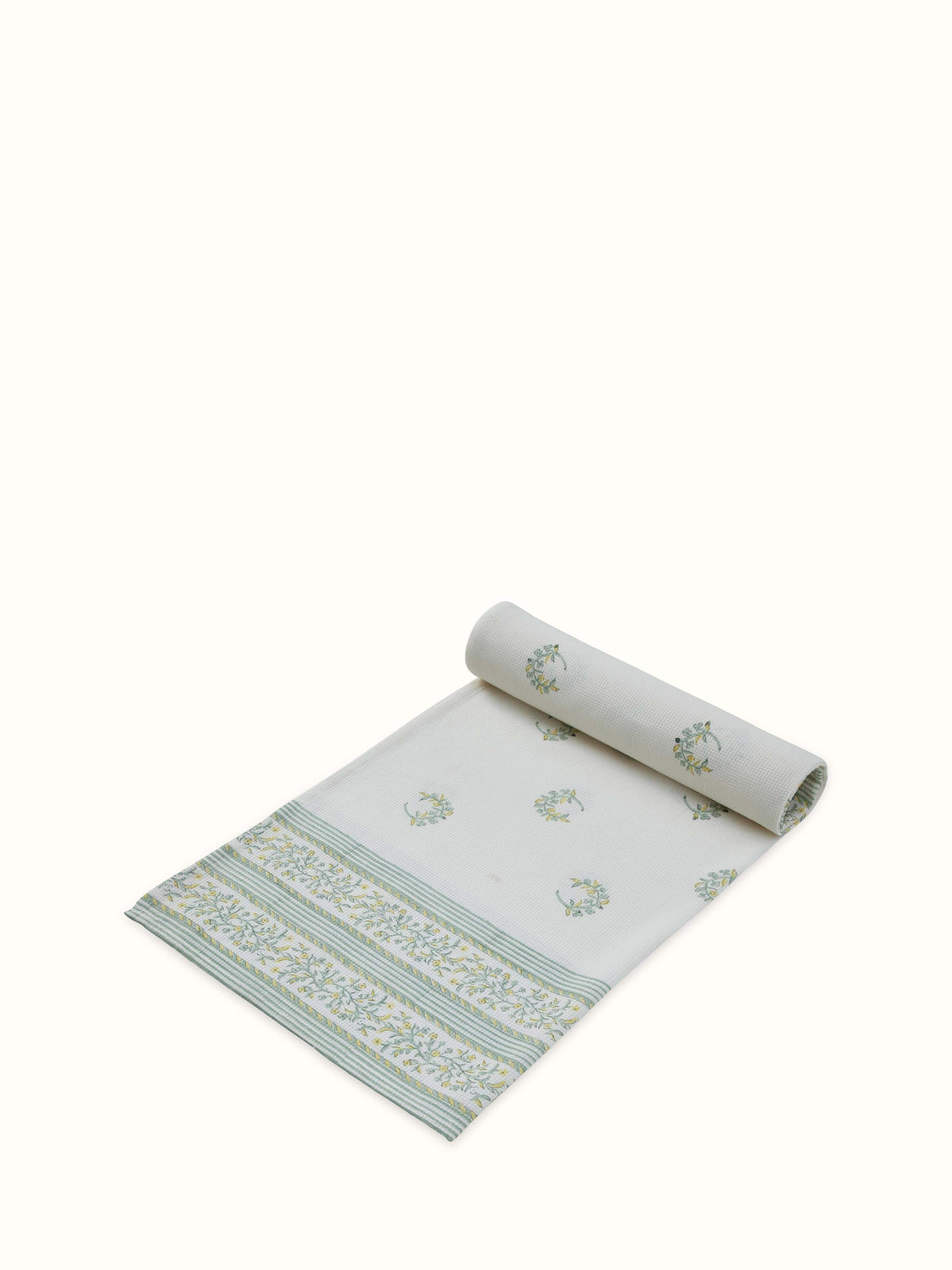 Detailed view of Ambi allover yellow floral cotton Sanganeri block printed bath towel (L) emphasizing the print texture and vibrant colors.