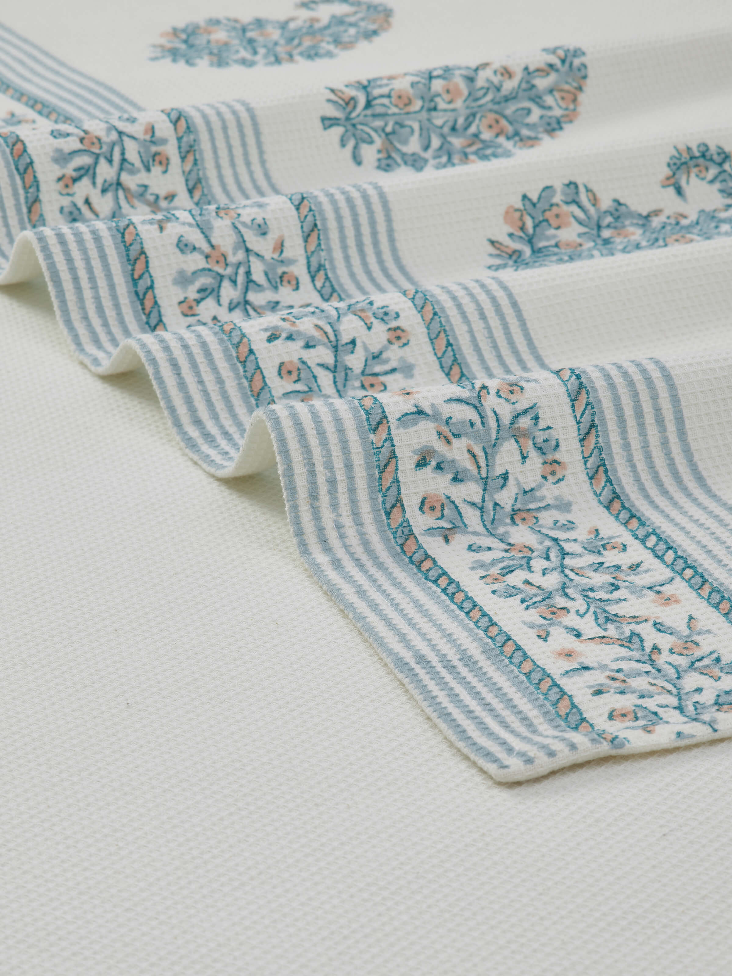 Ambi border blue floral cotton Sanganeri block printed bath towel (XL), showing the towel laid out to display its full size.