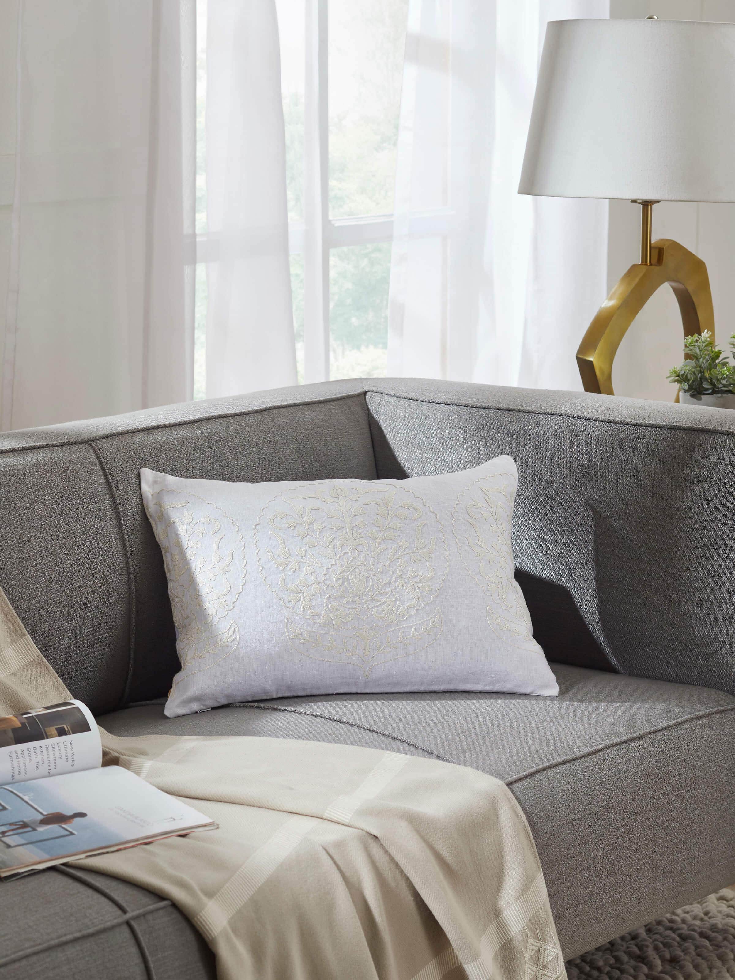 Close-up of Razza ivory carnation allover linen crewel hand-embroidered cushion cover, highlighting the detailed hand-embroidered floral design