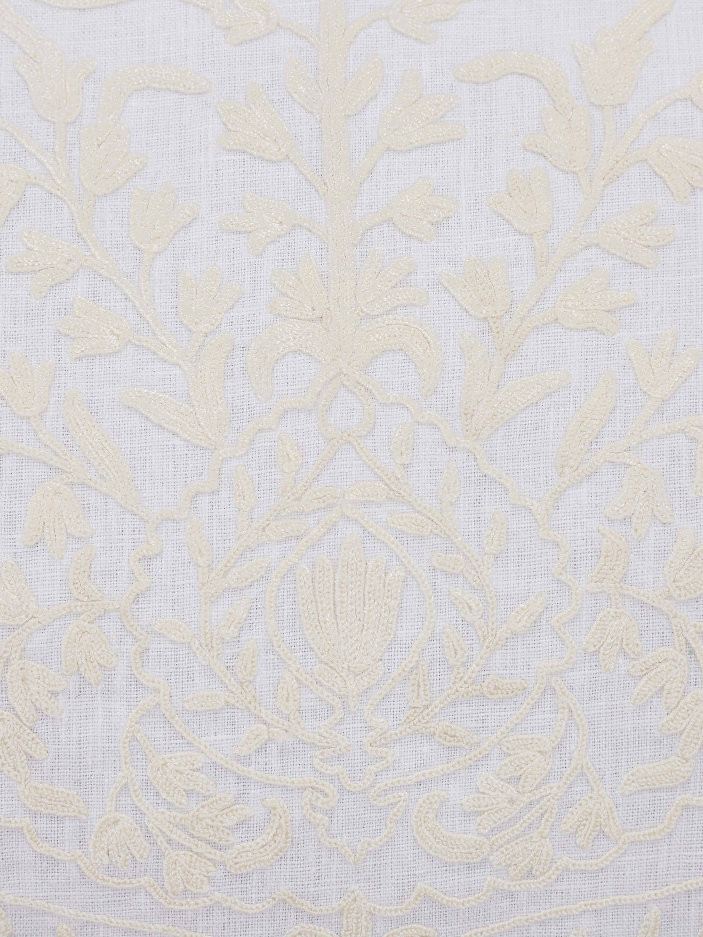 Side view of Razza ivory carnation allover linen crewel hand-embroidered cushion cover, demonstrating the cushion’s thickness and embroidery edges