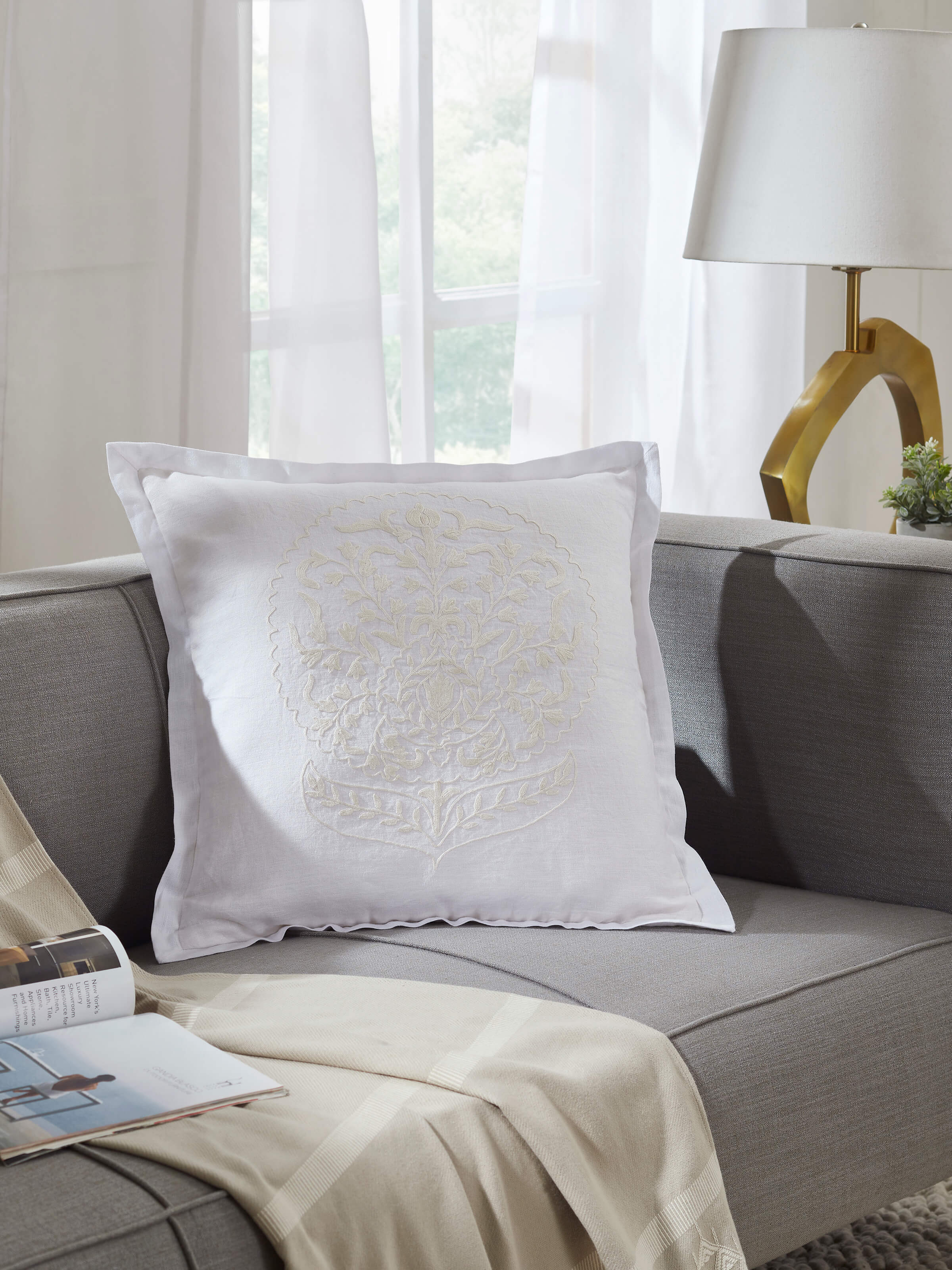 Side view of Razza ivory carnation buta linen crewel hand-embroidered cushion cover highlighting the depth of the embroidery