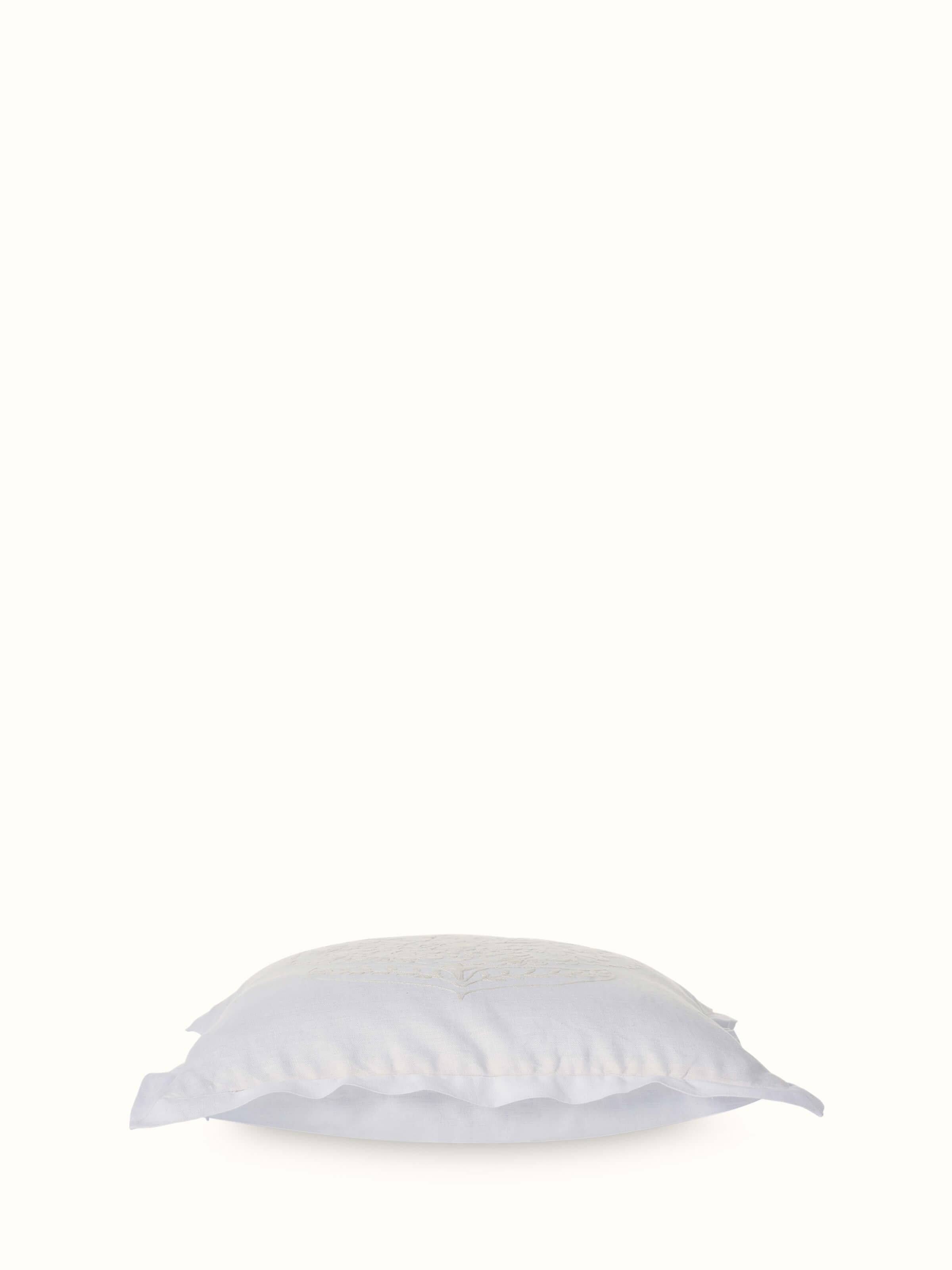 Angled view of Razza ivory carnation buta linen crewel hand-embroidered cushion cover displaying its design and texture