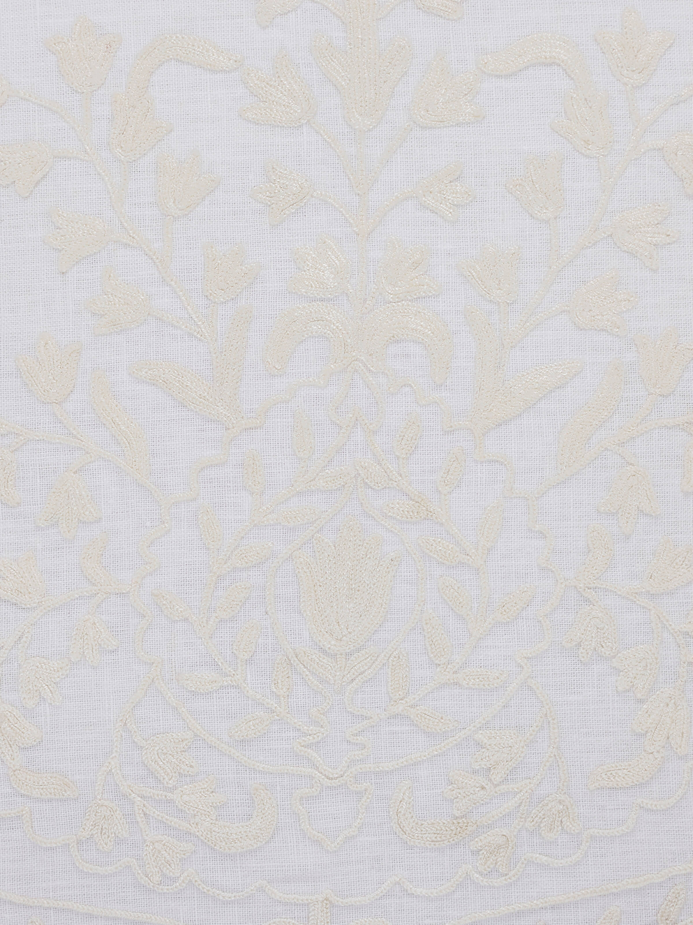 Close-up of Razza ivory carnation buta linen crewel hand-embroidered cushion cover emphasizing the detailed stitching and patterns