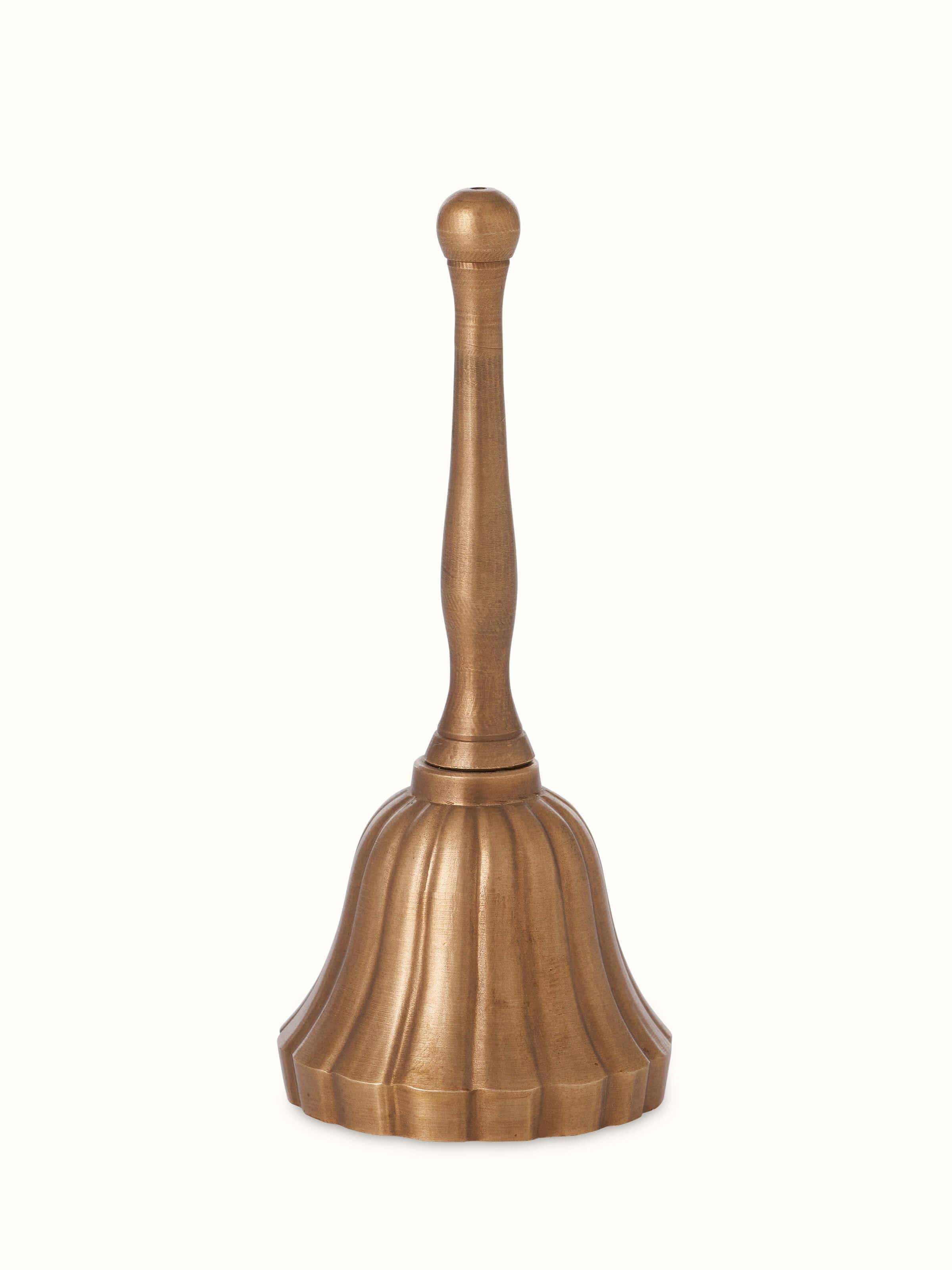 Front view of polished brass curved pooja bell, highlighting its shiny finish