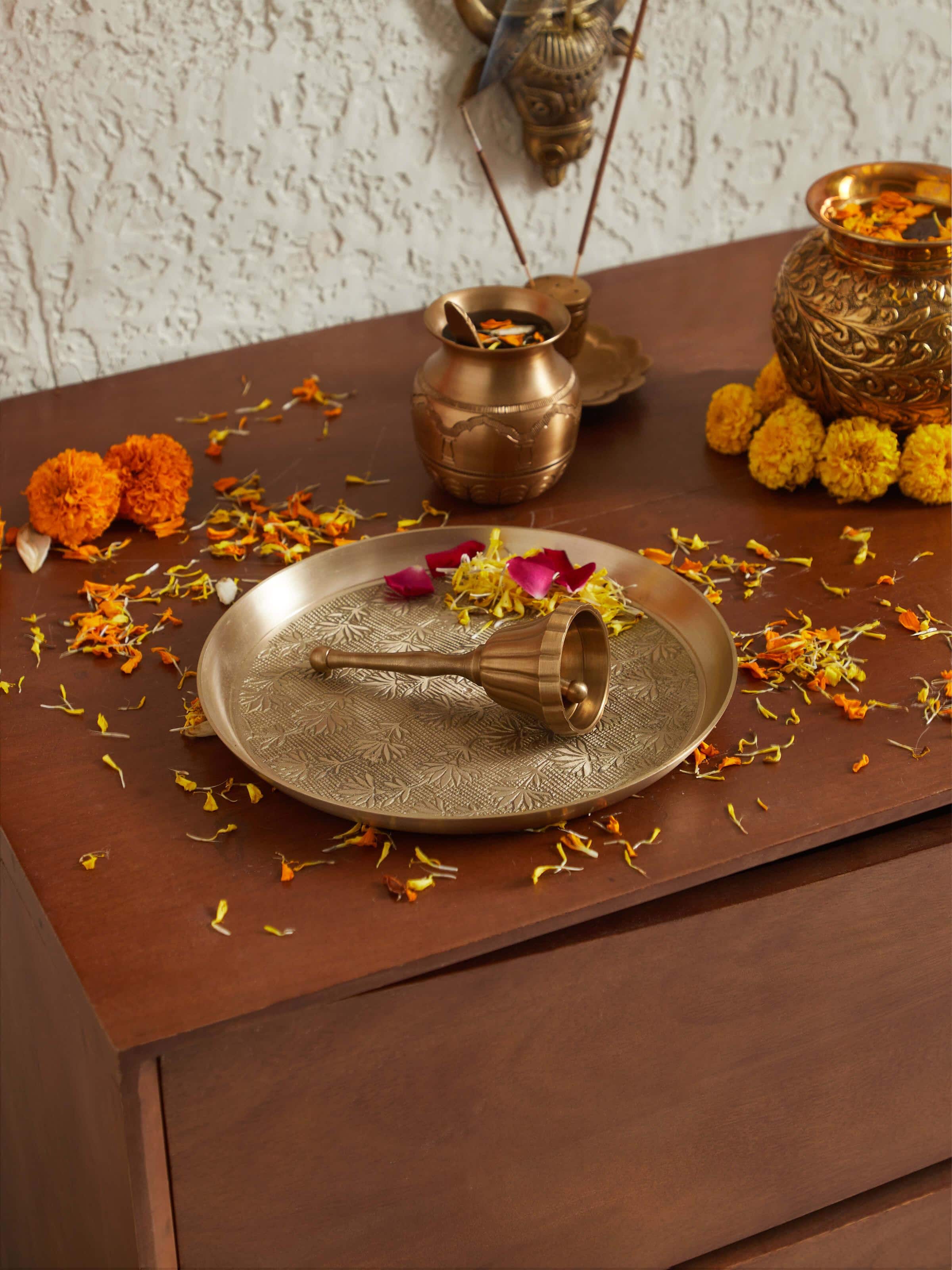 Side view of polished brass curved pooja bell, showcasing its elegant curve