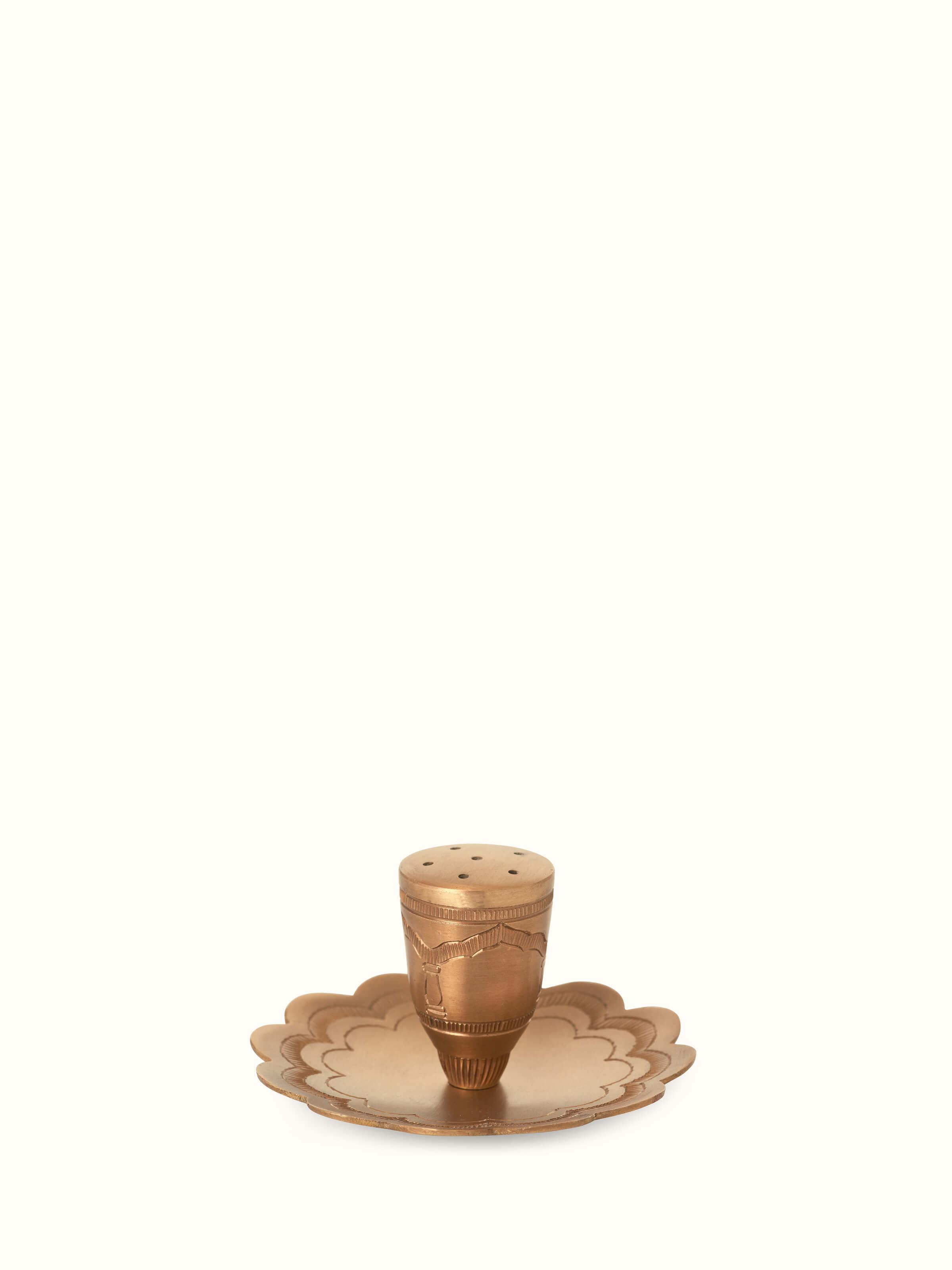 Front view of polished brass incense stick holder showcasing its elegant, reflective surface and detailed design