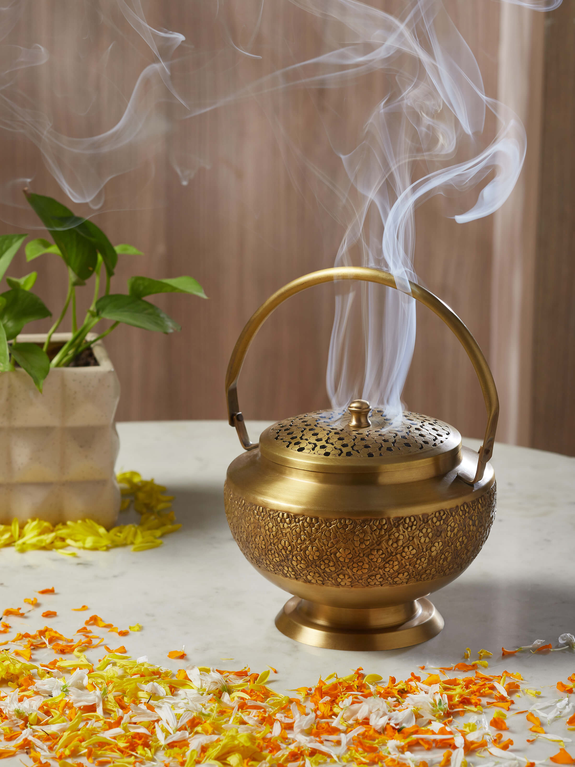 Side view of traditional polished brass dhuna showcasing its elegant design