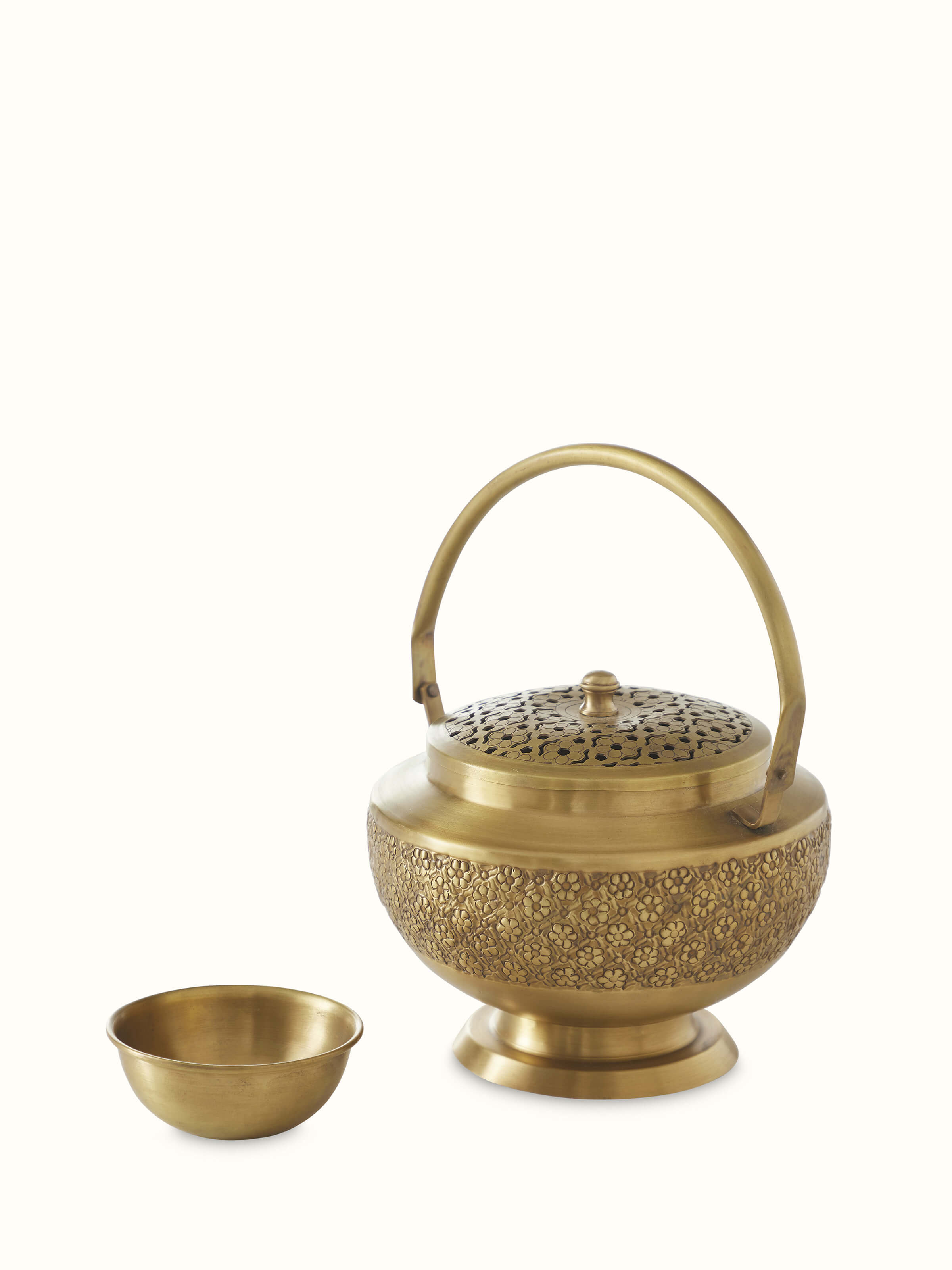 Close-up of traditional polished brass dhuna highlighting its fine craftsmanship