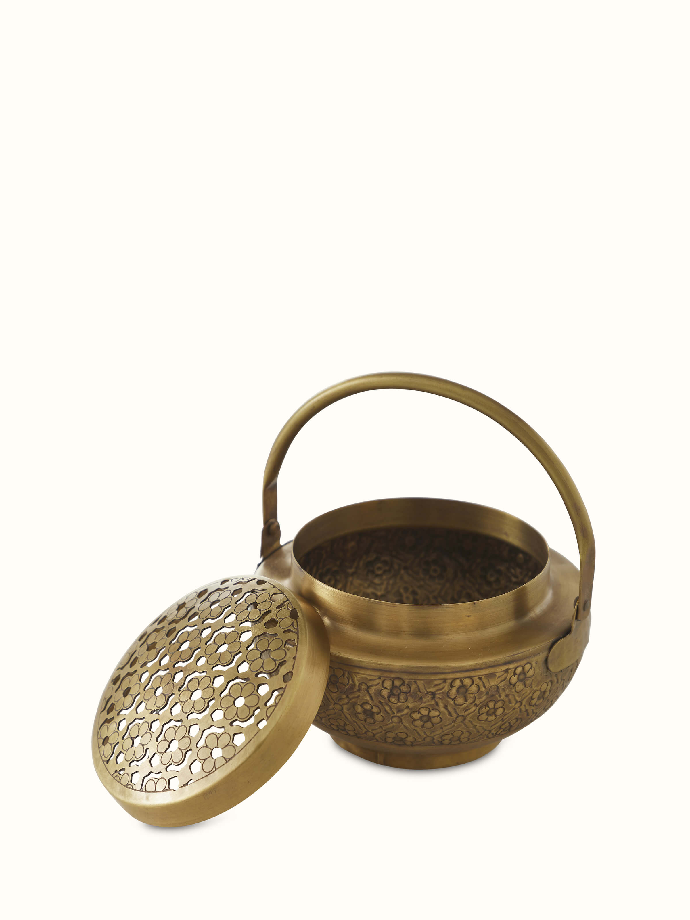 Detailed view of traditional polished brass dhuna with visible artistry