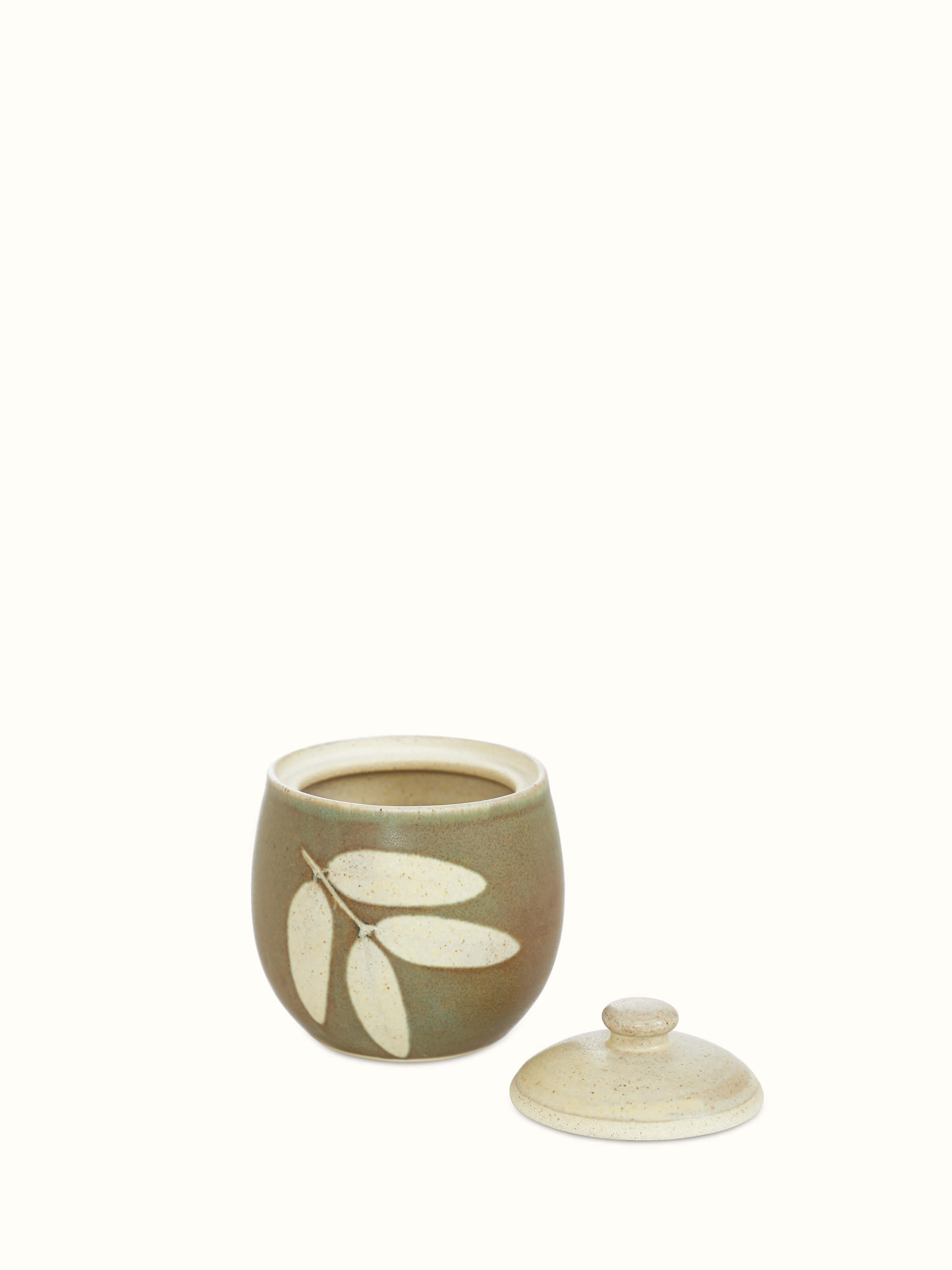 Angled view of Studio pottery ceramic jar with lid emphasizing the artistic glaze and refined contours